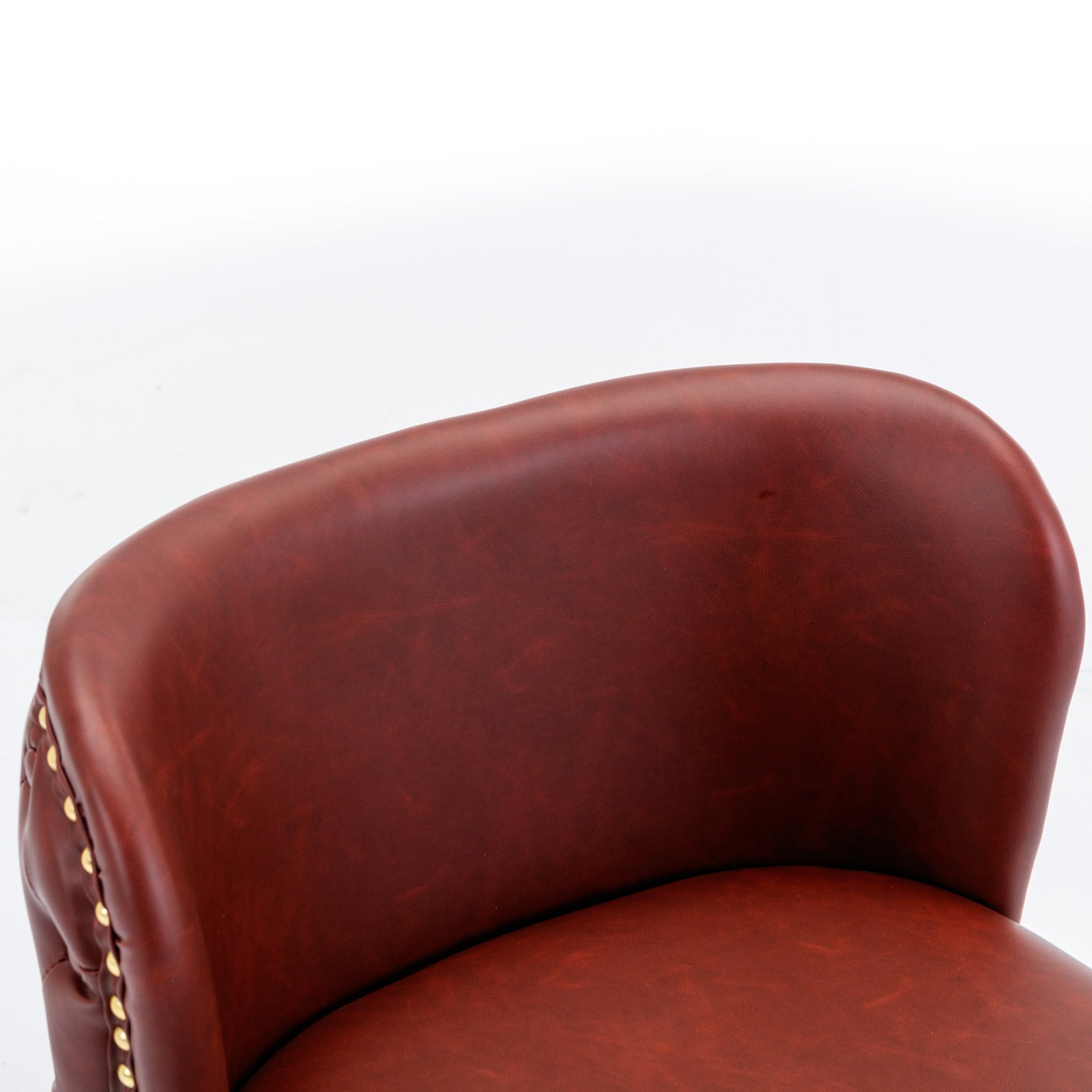 Brown faux leather tufted accent chair detail with gold nailhead trim