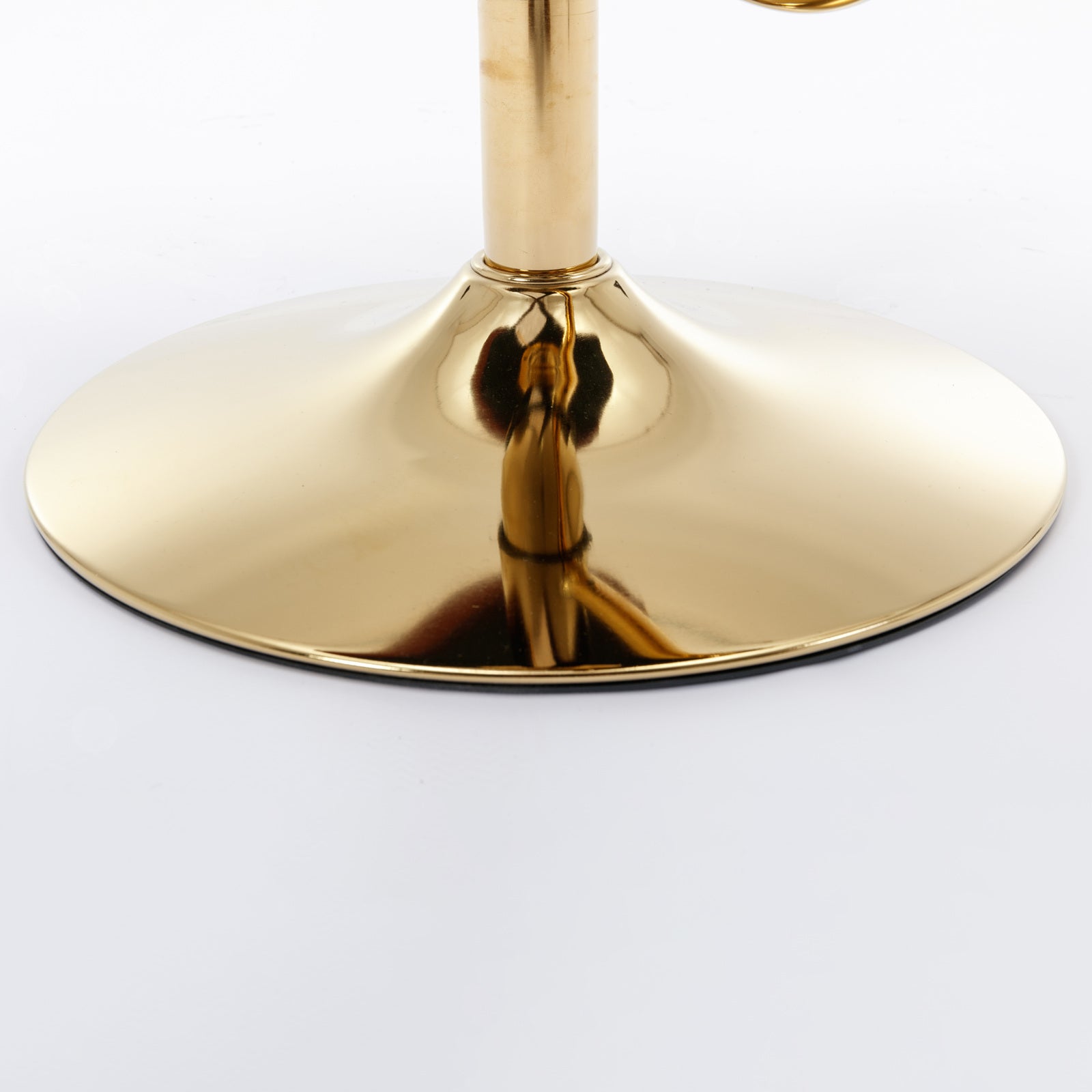 Shiny gold metal base of a swivel stool