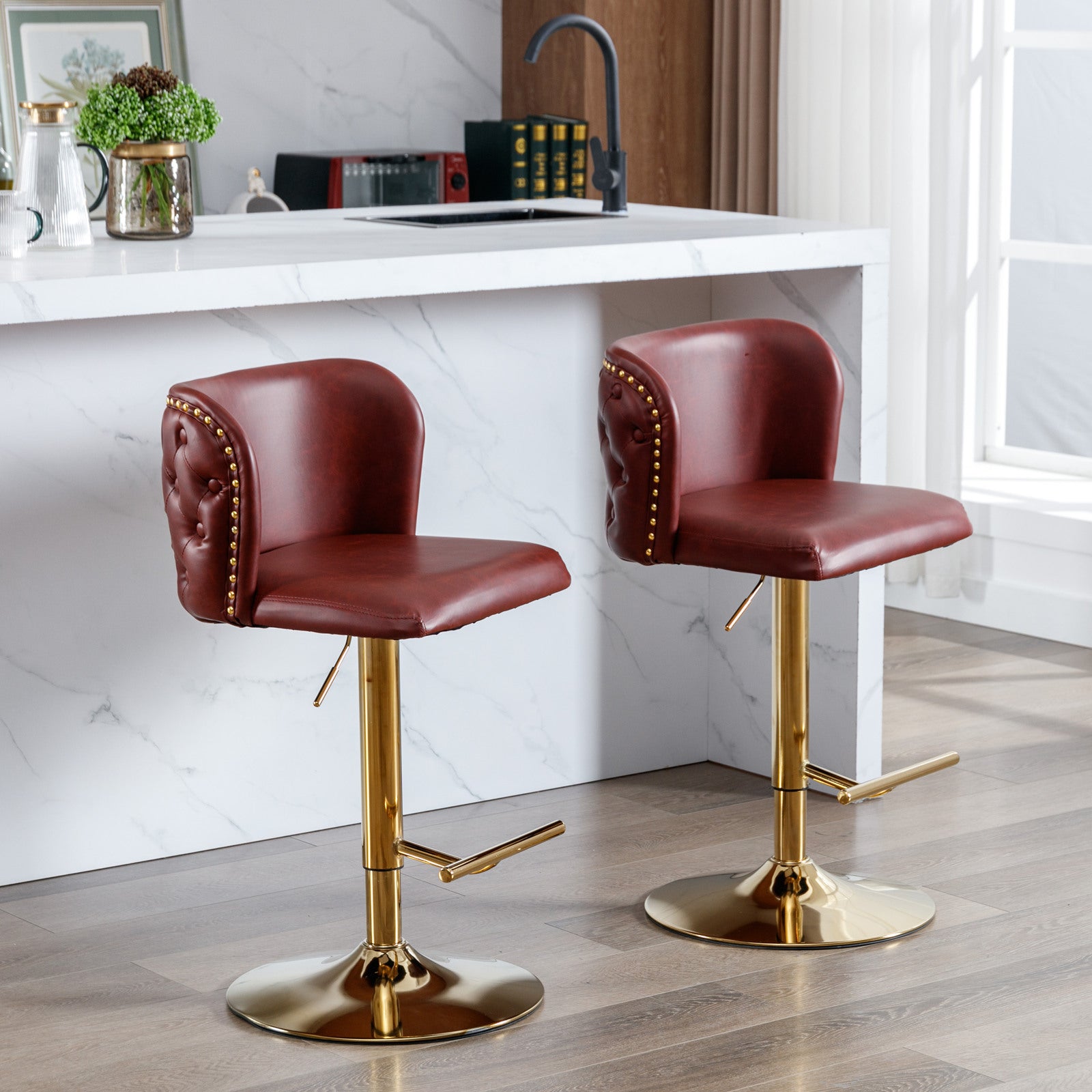 Red tufted faux leather bar stool with gold base and studs