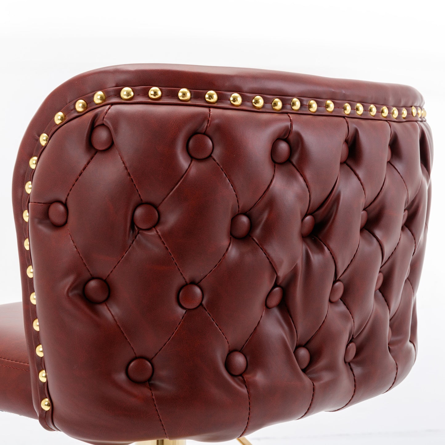 Deep red faux leather tufted bar stool with gold nailhead trim
