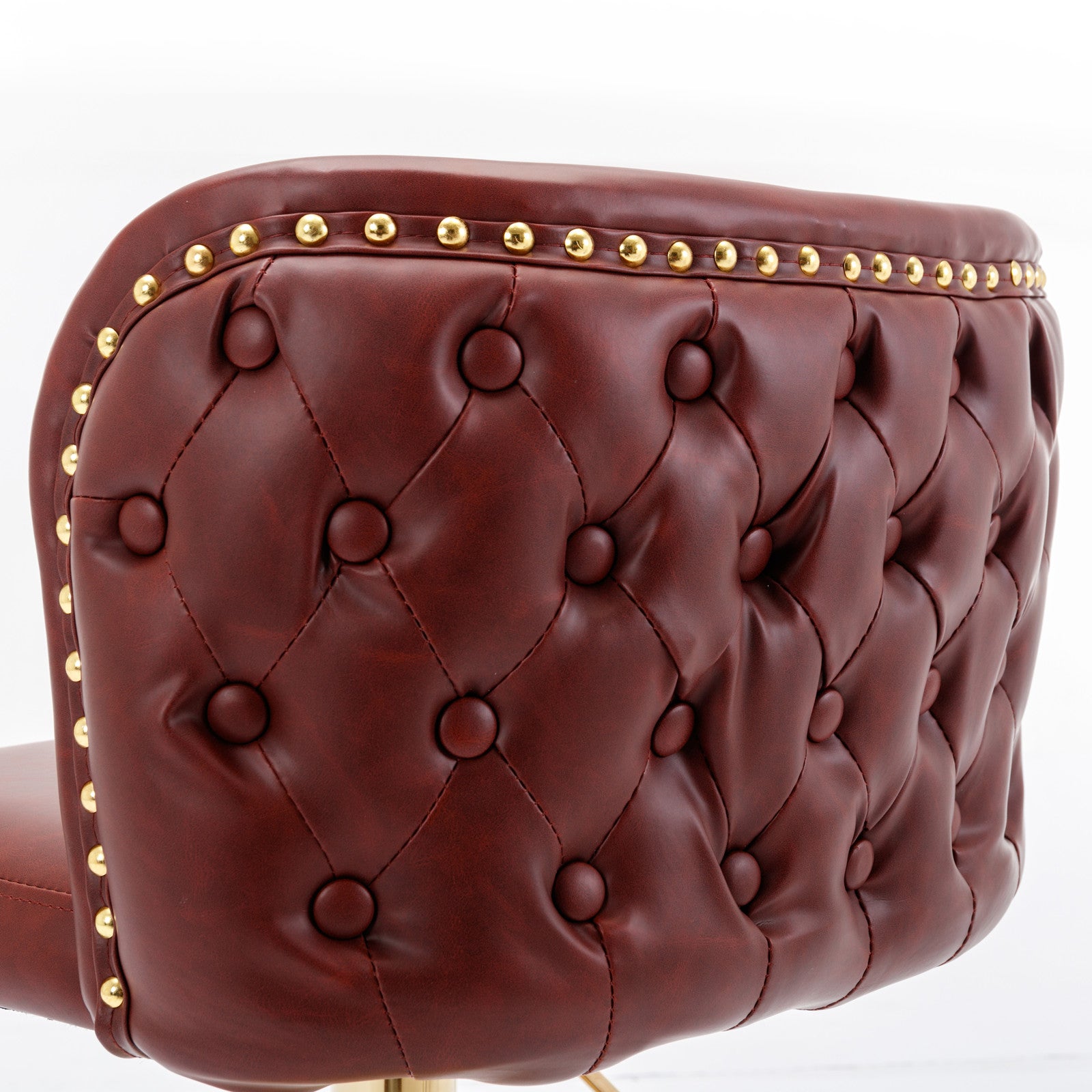 Deep red faux leather tufted bar stool with gold nailhead trim