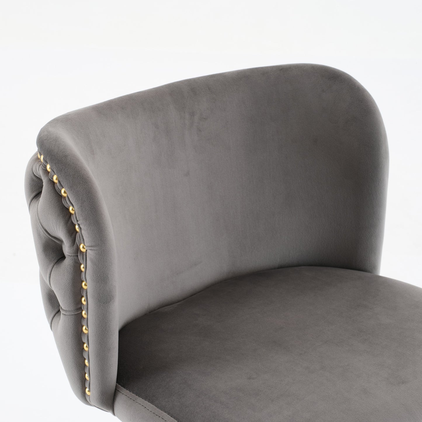 Grey velvet bar stool with tufted back and gold nailhead trim detail