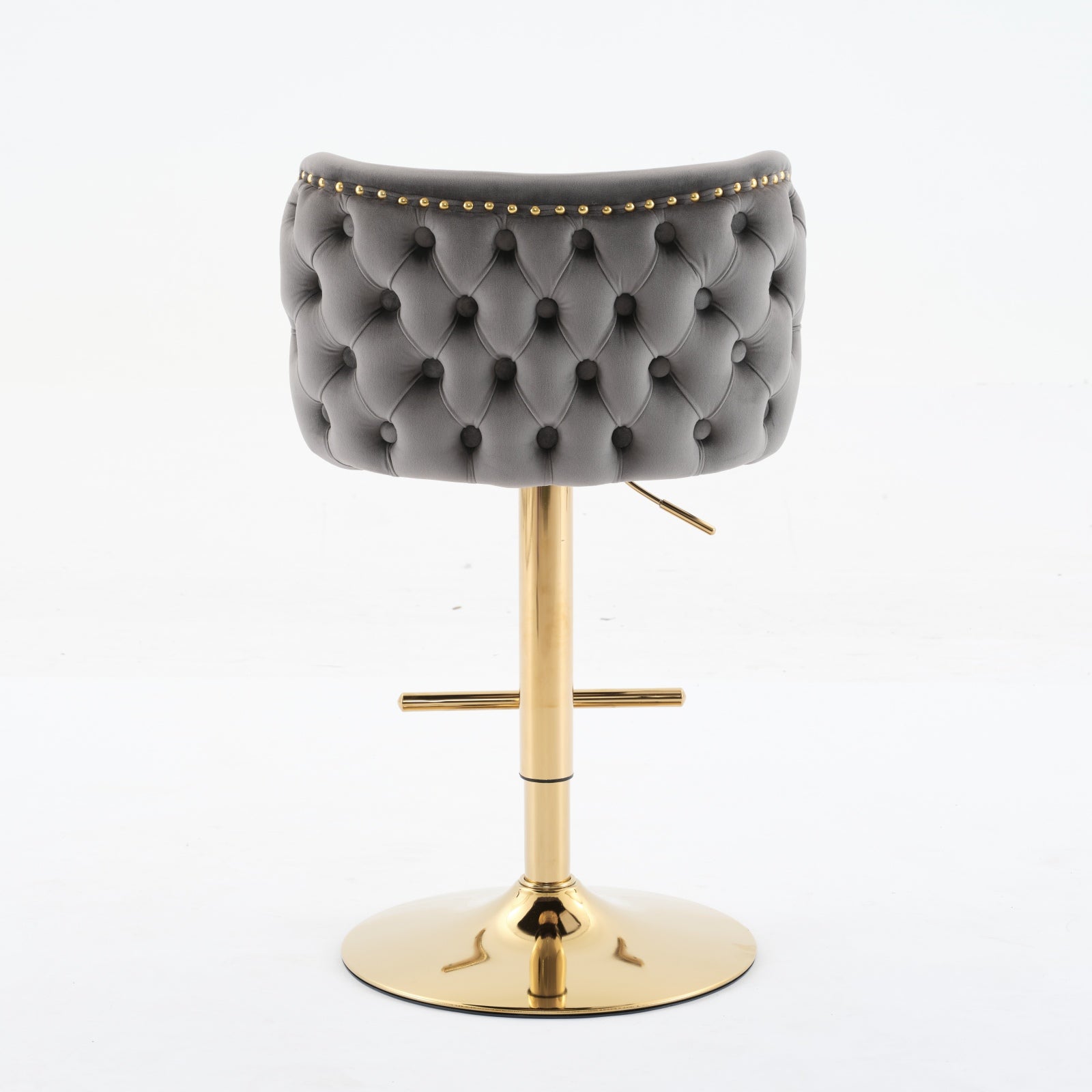 Tufted grey velvet bar stool with gold accent studs and adjustable gold base