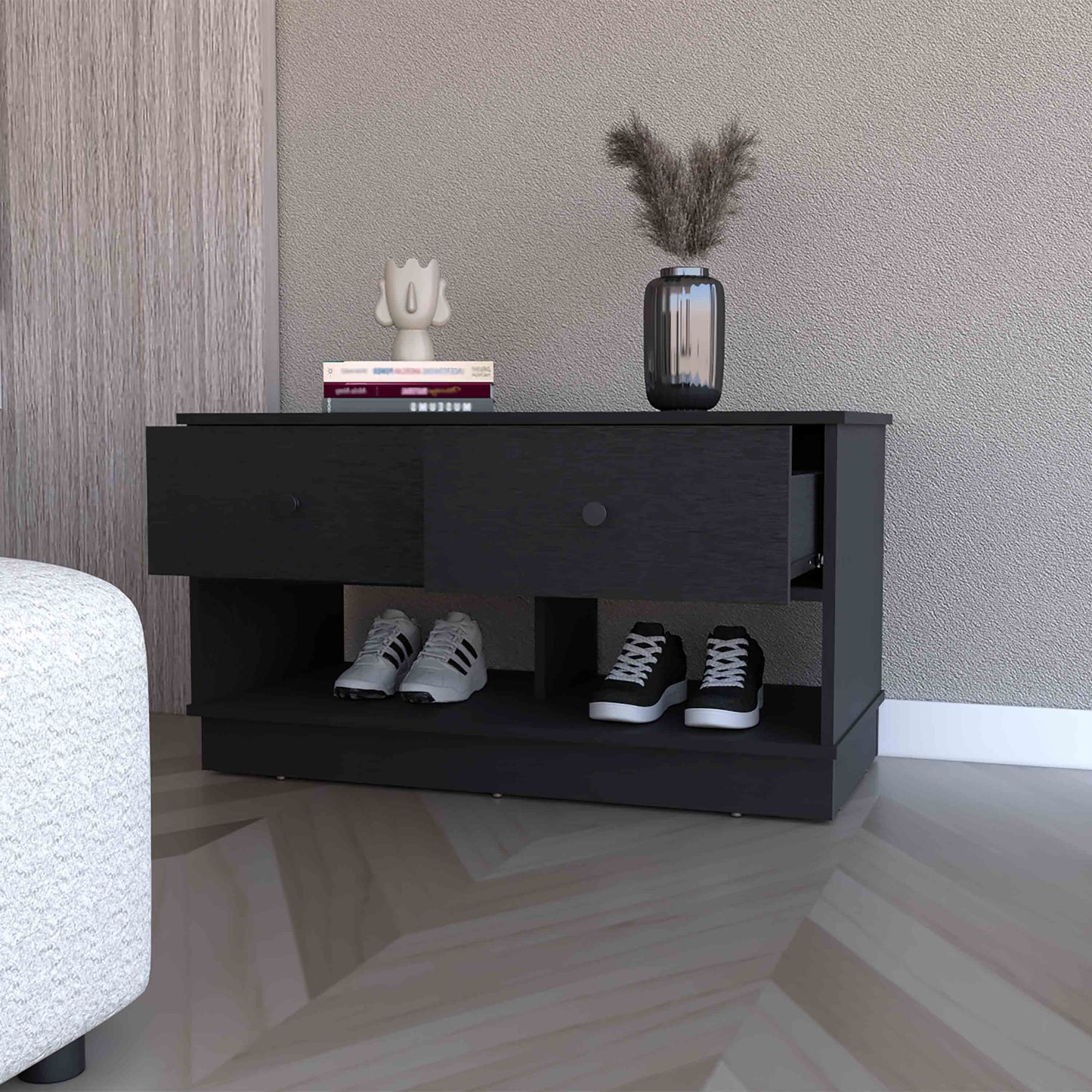 Modern black entryway shoe bench with two drawers and open shelving holding sneakers
