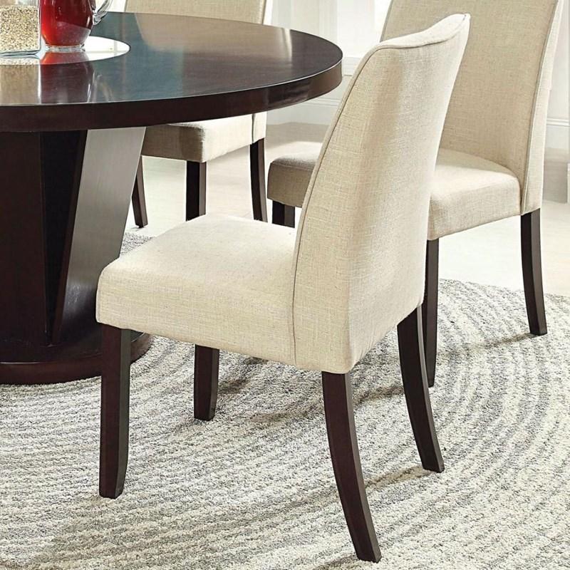 Upholstered dining chair in cream fabric with dark wood legs