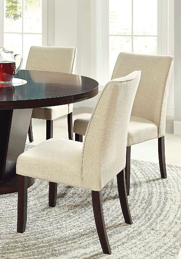 Upholstered dining chairs in light beige linen fabric with dark wood legs