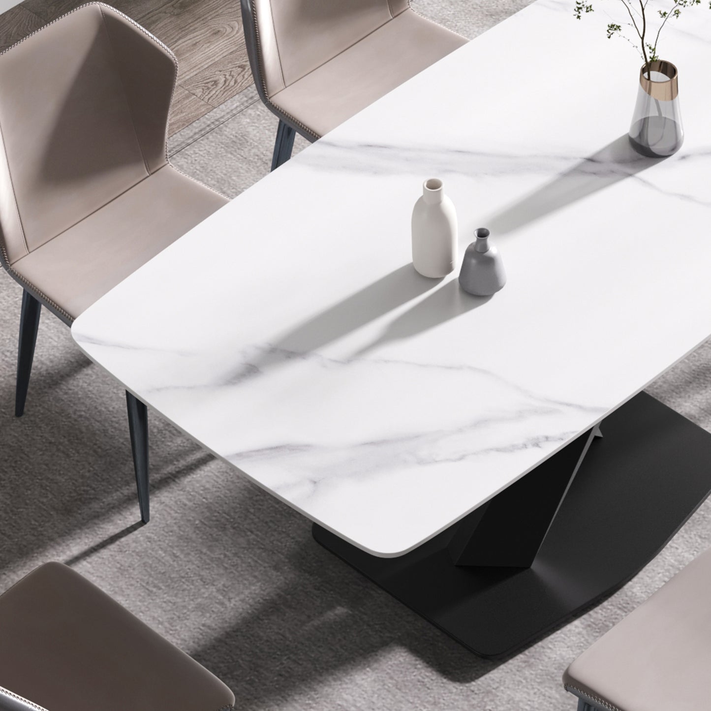 White marble dining table with sleek black base and tan upholstered chairs