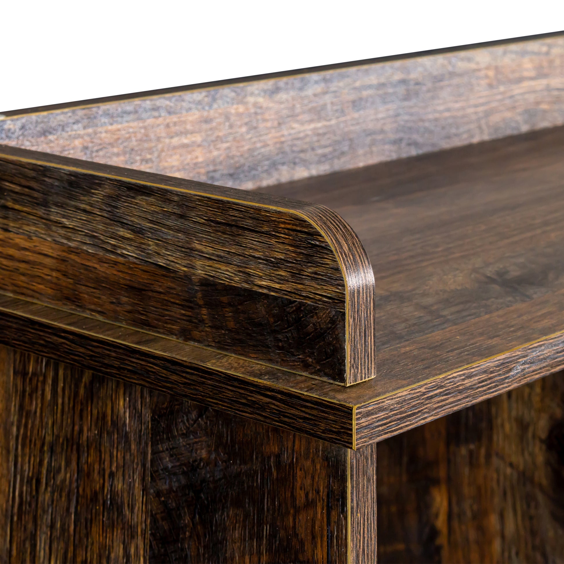Dark wood veneer bookshelf edge detail with golden trim