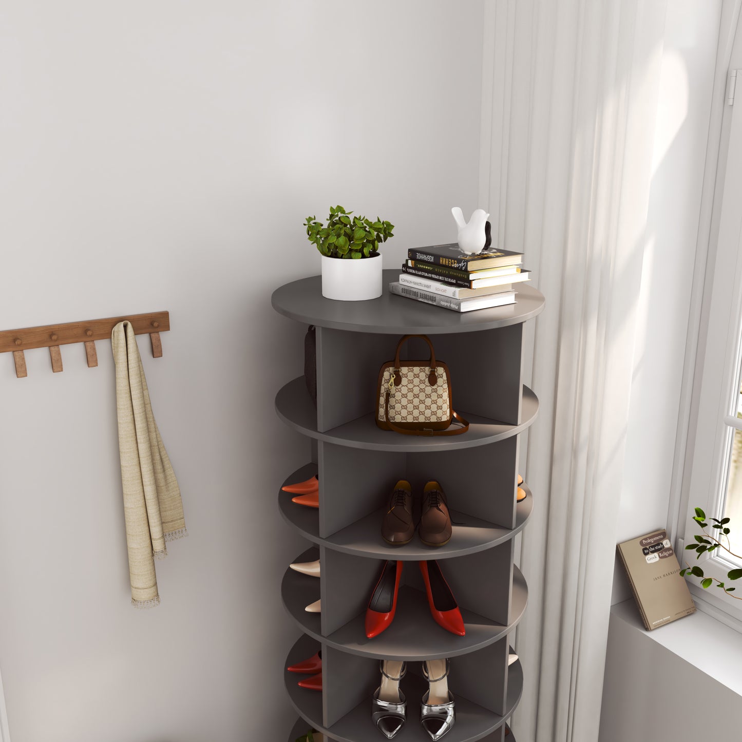 Grey rotating shoe rack with tan handbag and shoes