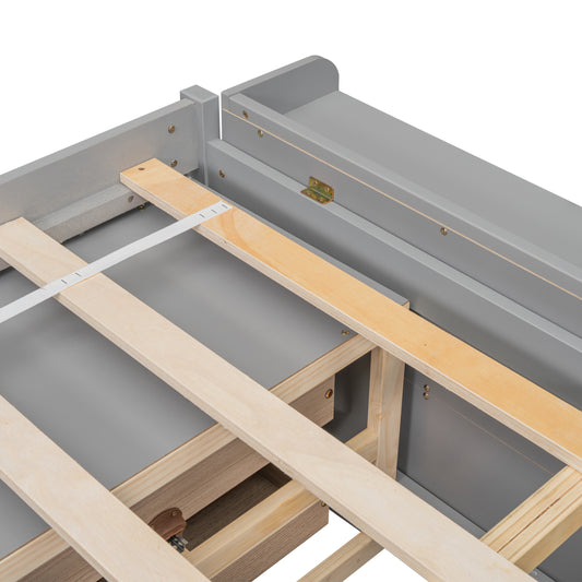 Closeup of a grey upholstered bed frame with wooden slats and white strap