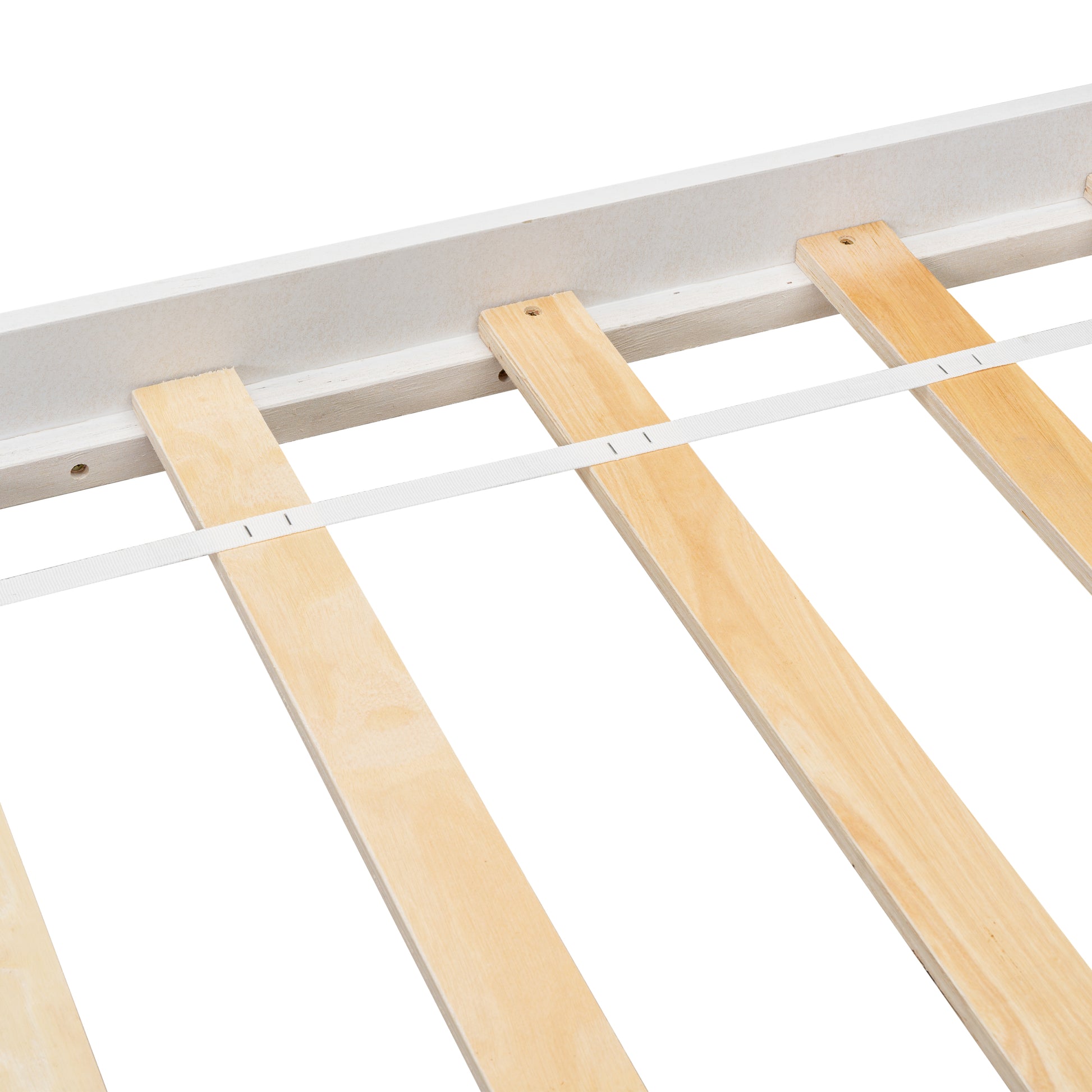 Closeup of white bed frame with natural wood slats and white strap support