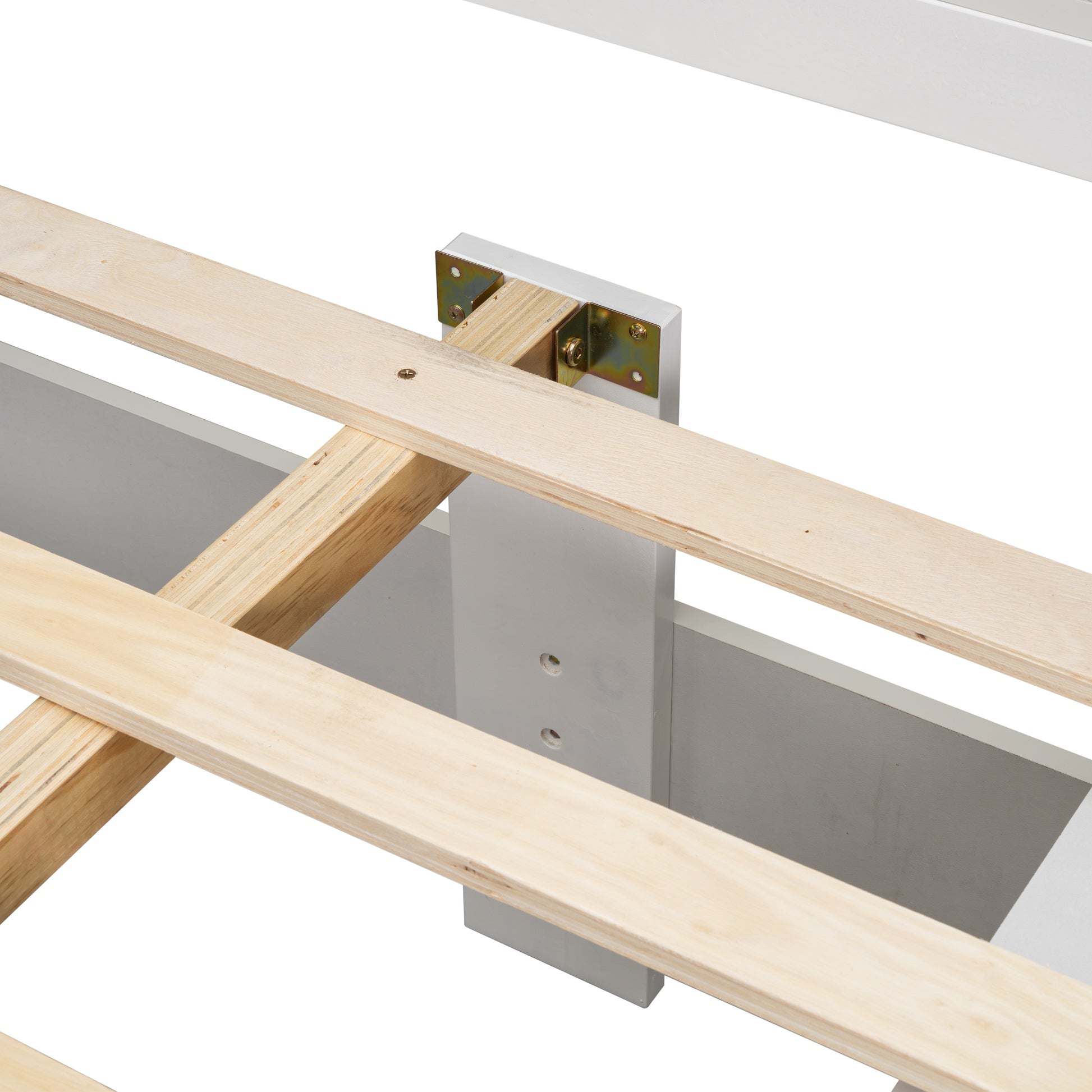 Closeup of wooden bed frame slats and white support