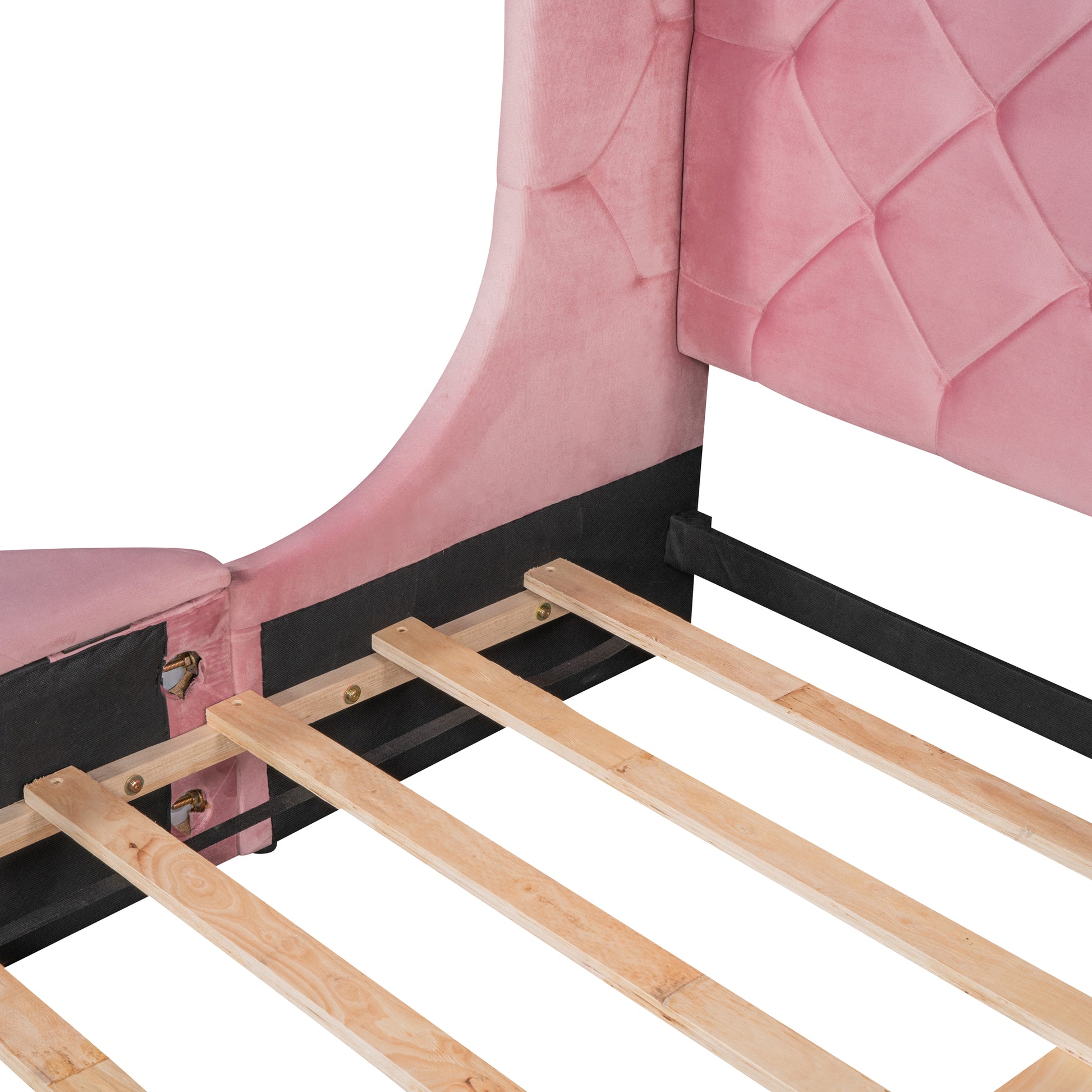 Pink velvet bed frame showing tufted headboard detail and wooden slats