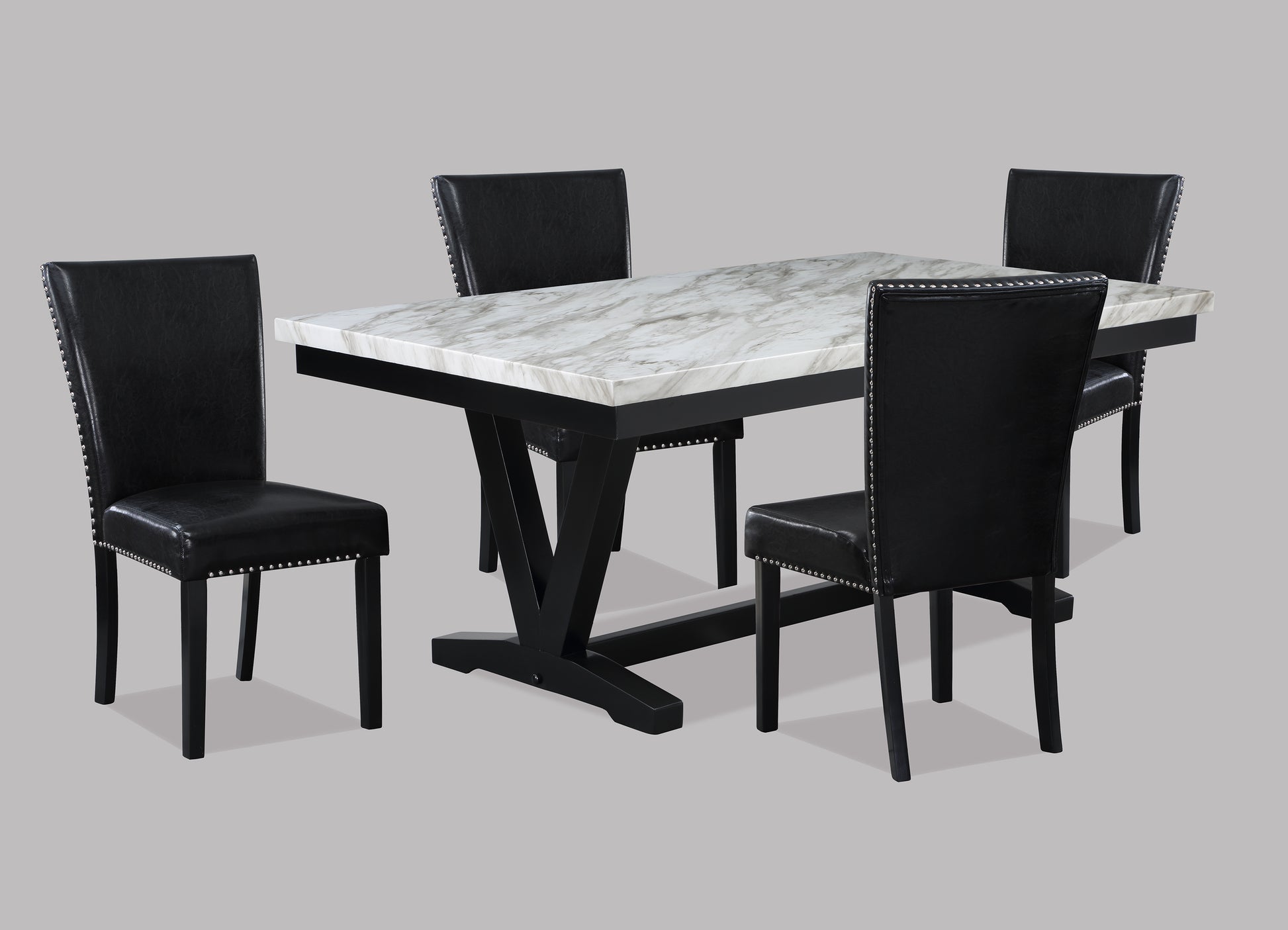 Modern faux marble dining table with four black leatherette chairs featuring silver nailhead trim