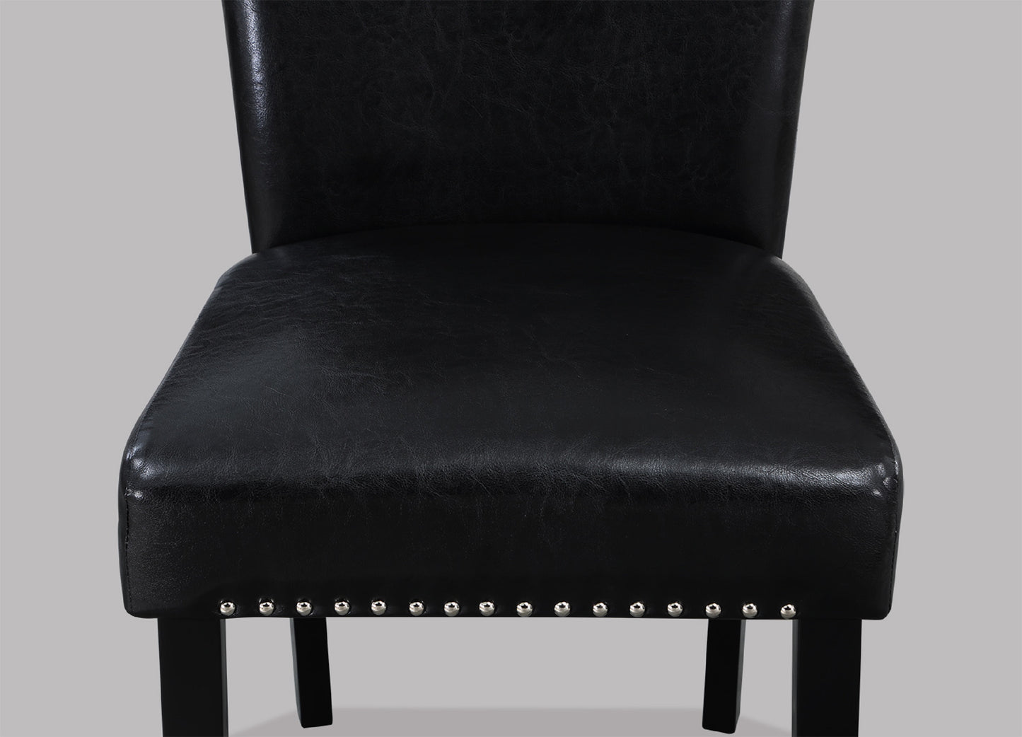 Black faux leather dining chair with nailhead trim