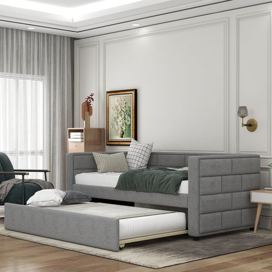 Gray upholstered daybed with pullout trundle perfect for guest rooms