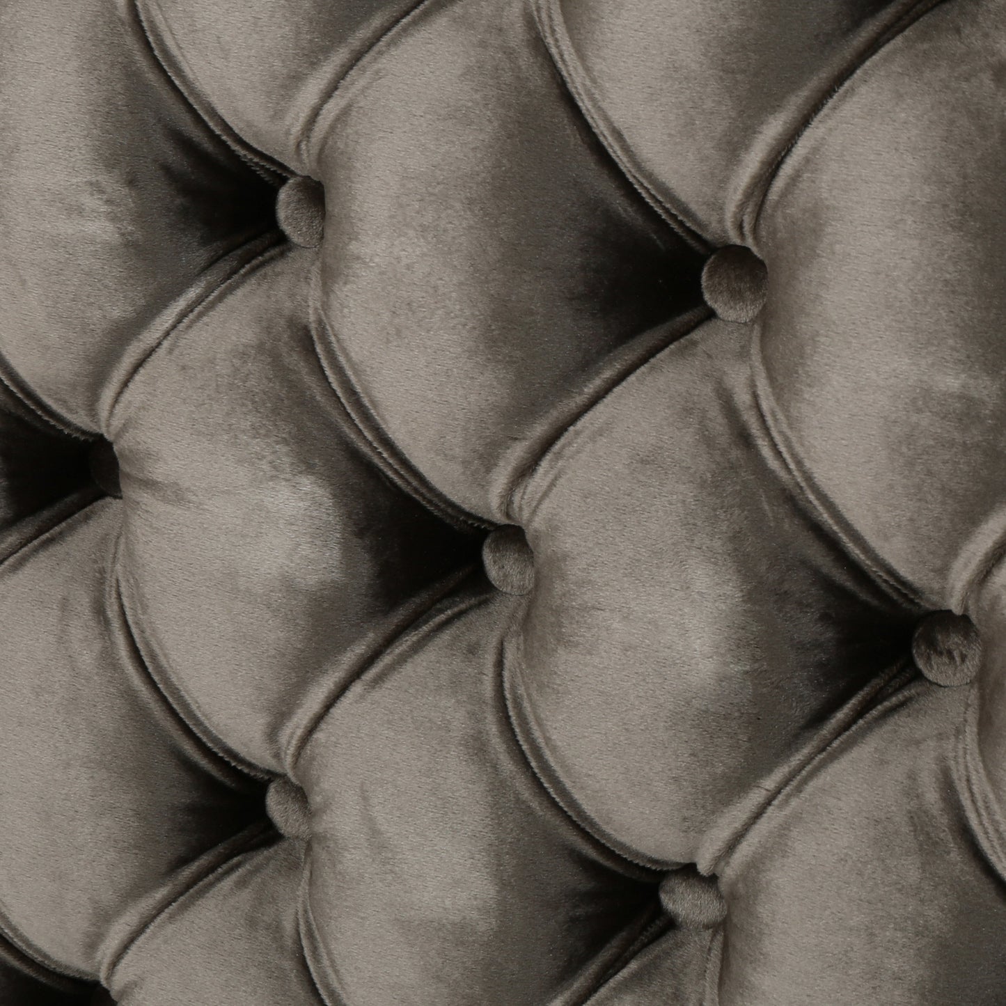 Closeup of grey velvet tufted upholstery