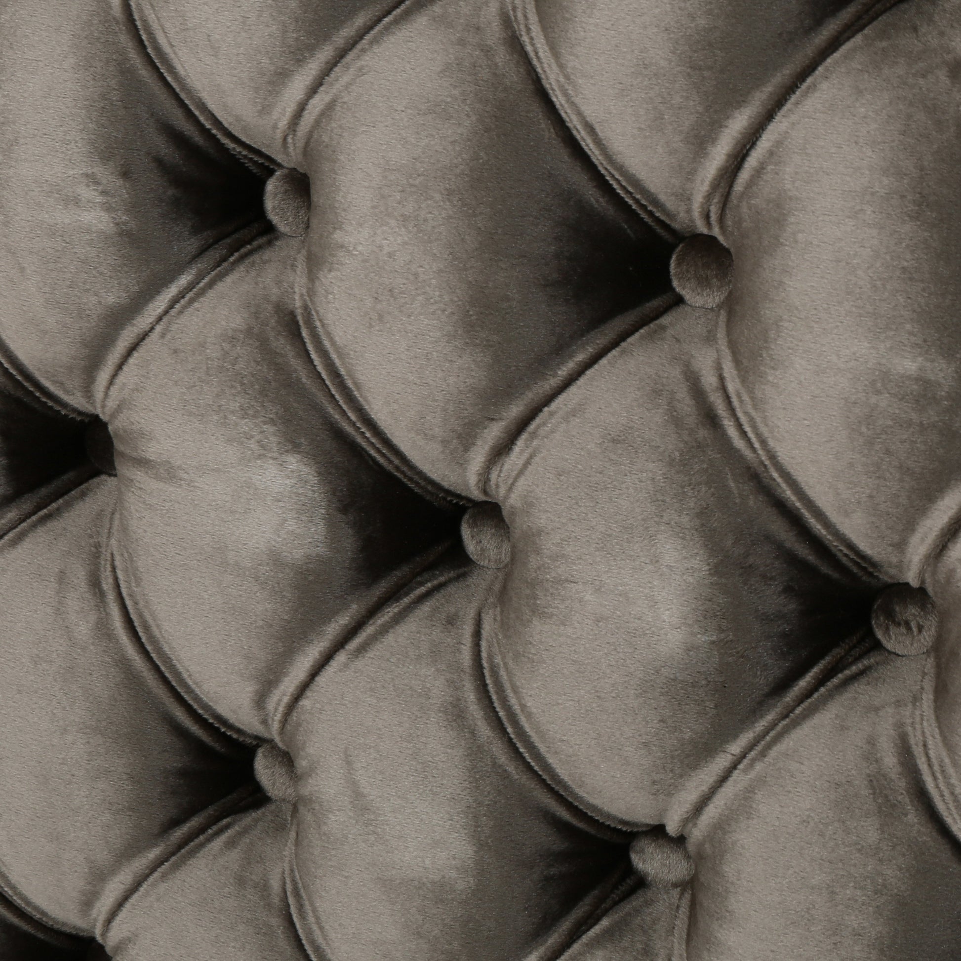 Closeup of grey velvet tufted upholstery