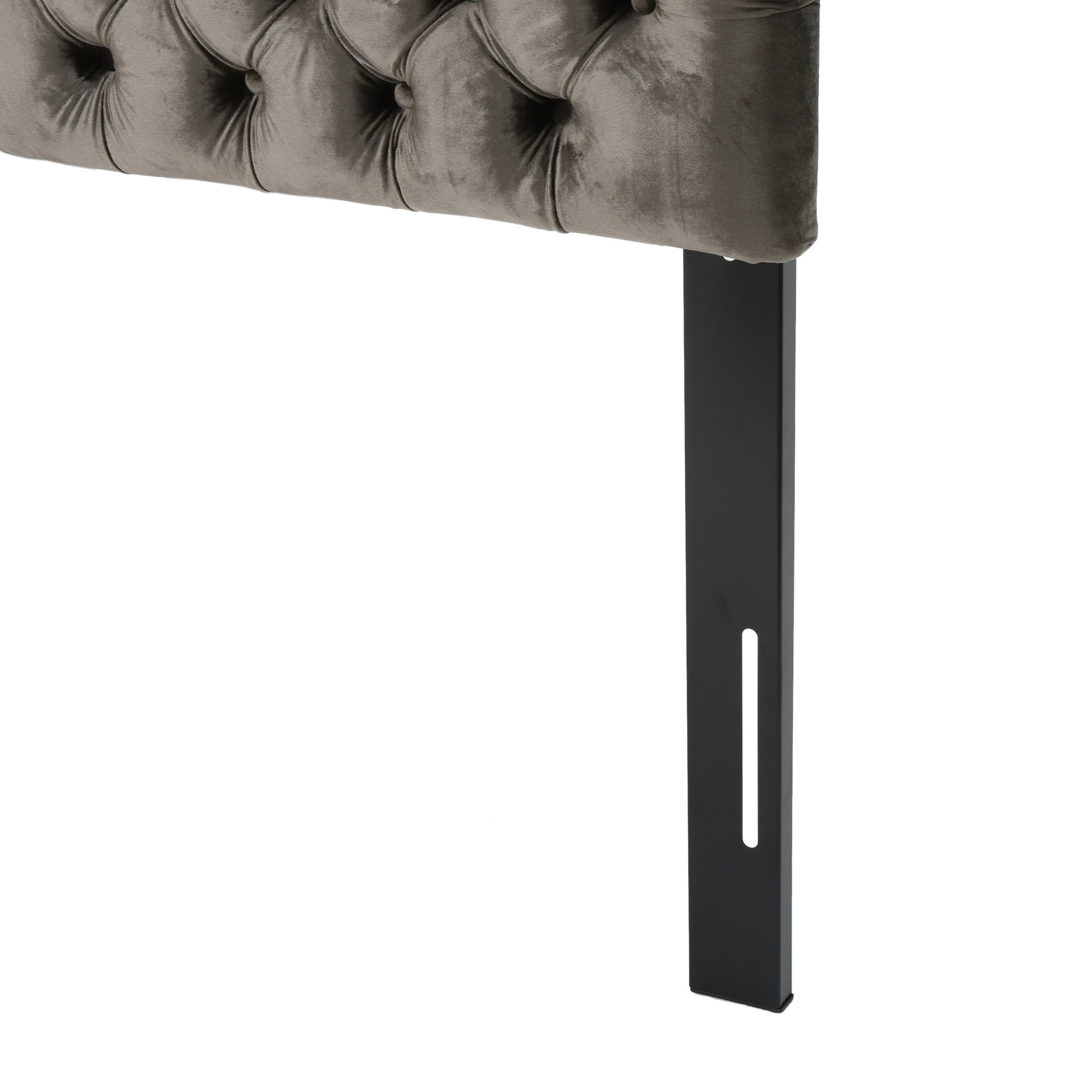 Grey velvet tufted headboard detail with black metal leg