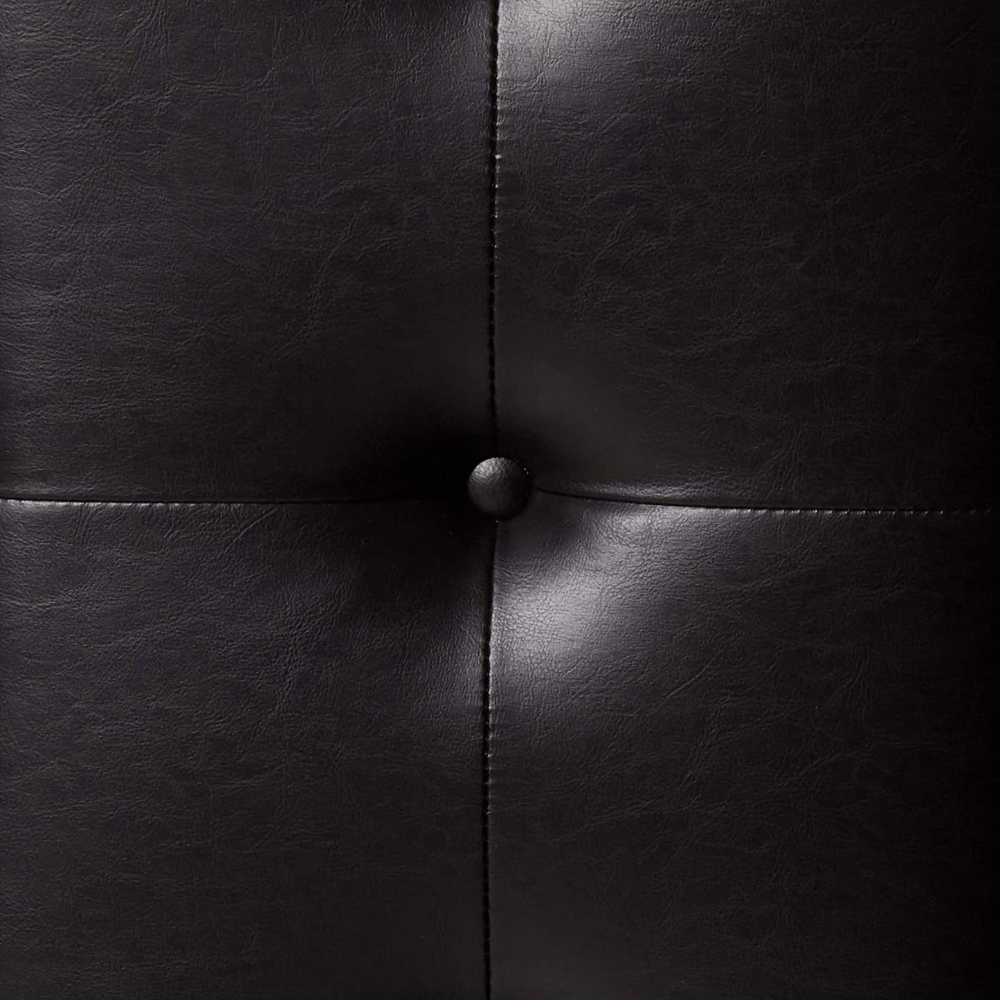 Black faux leather tufted accent chair detail