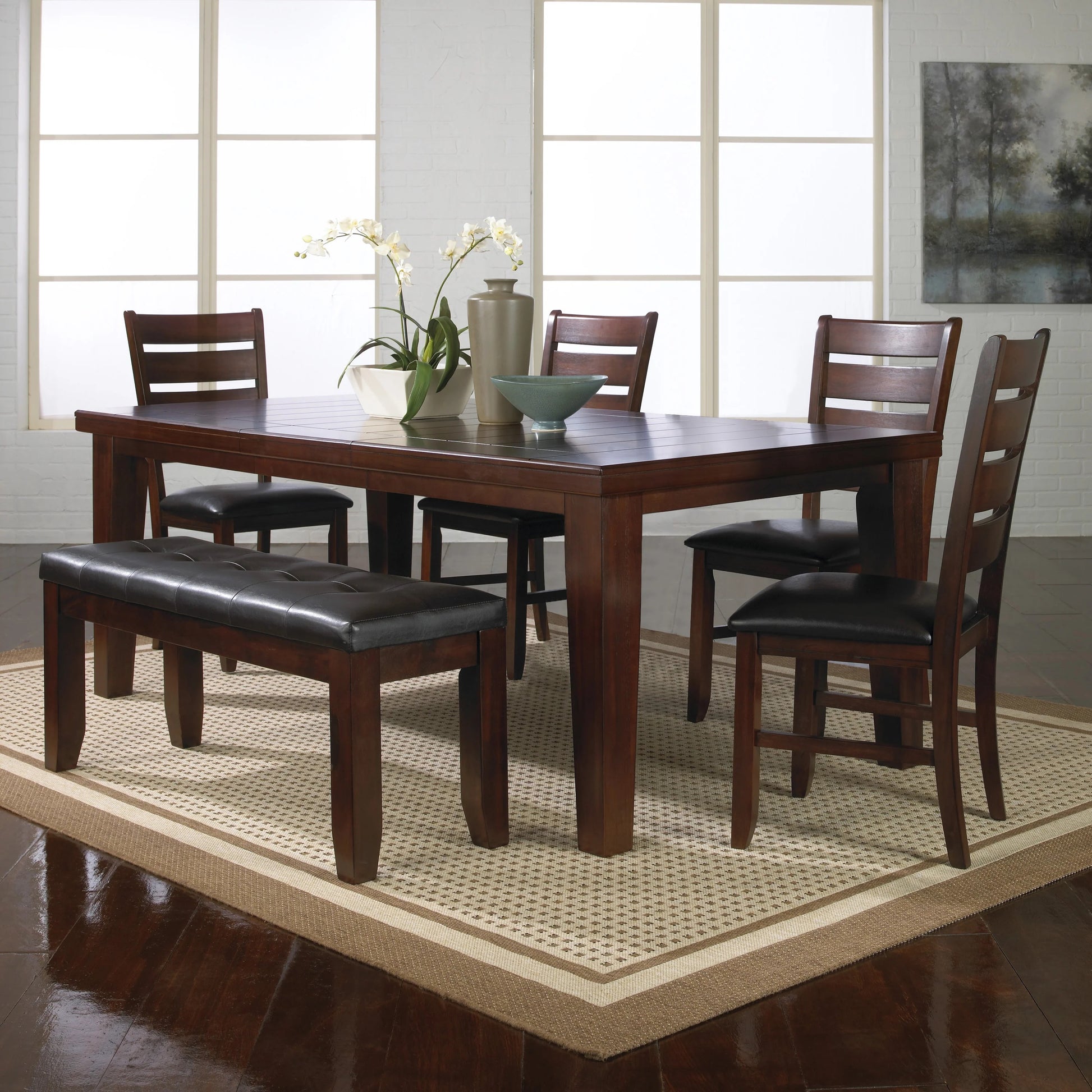 Dark wood dining table with tufted leather bench and chairs