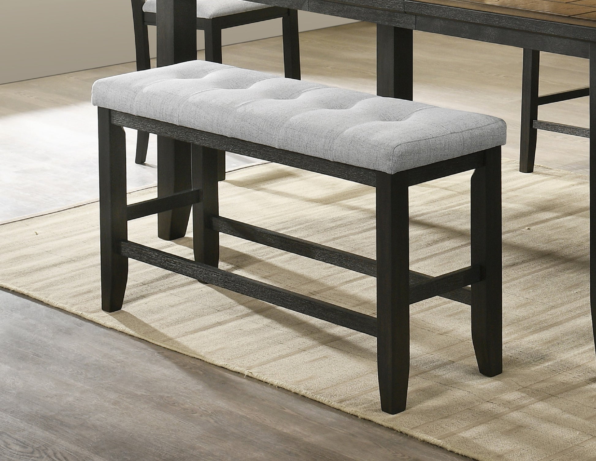 Tufted grey upholstered counter bench with dark wood legs