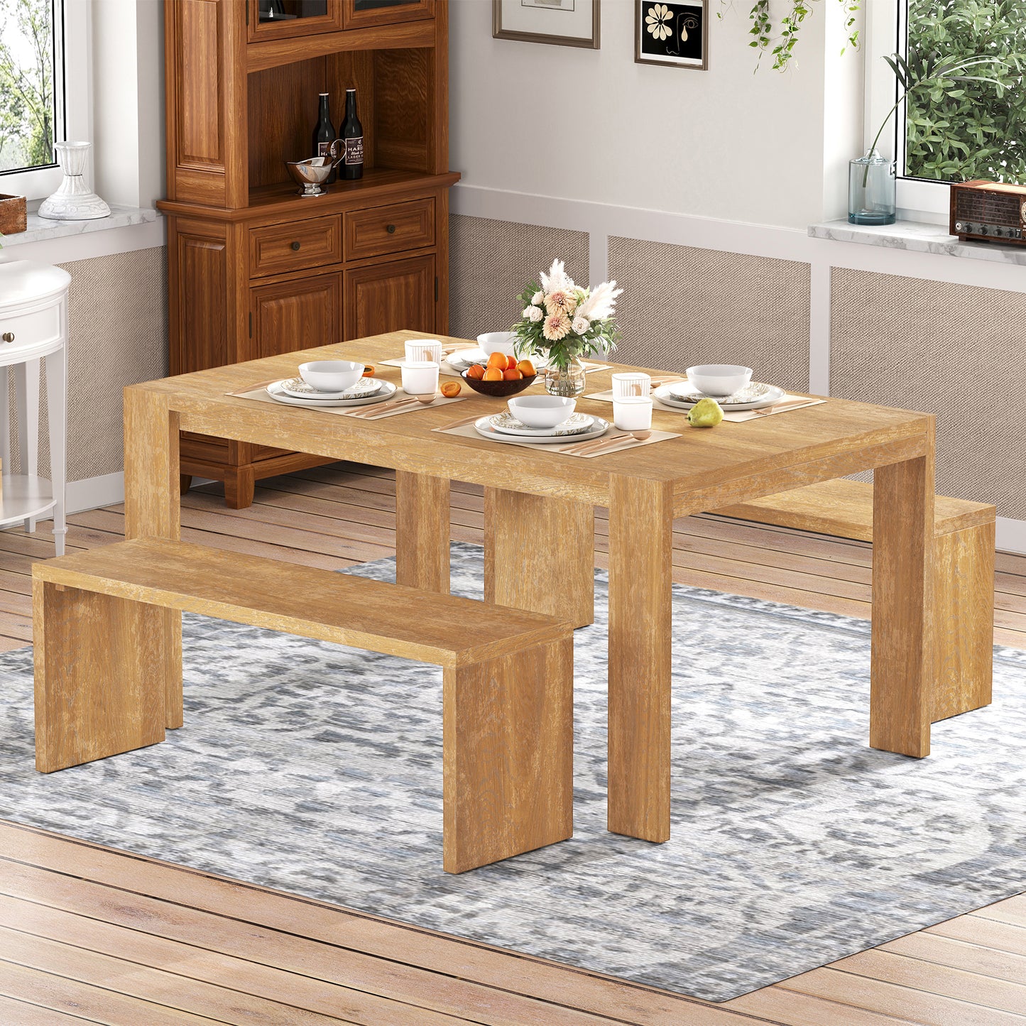 Rustic wood dining table with modern bench seating on patterned rug