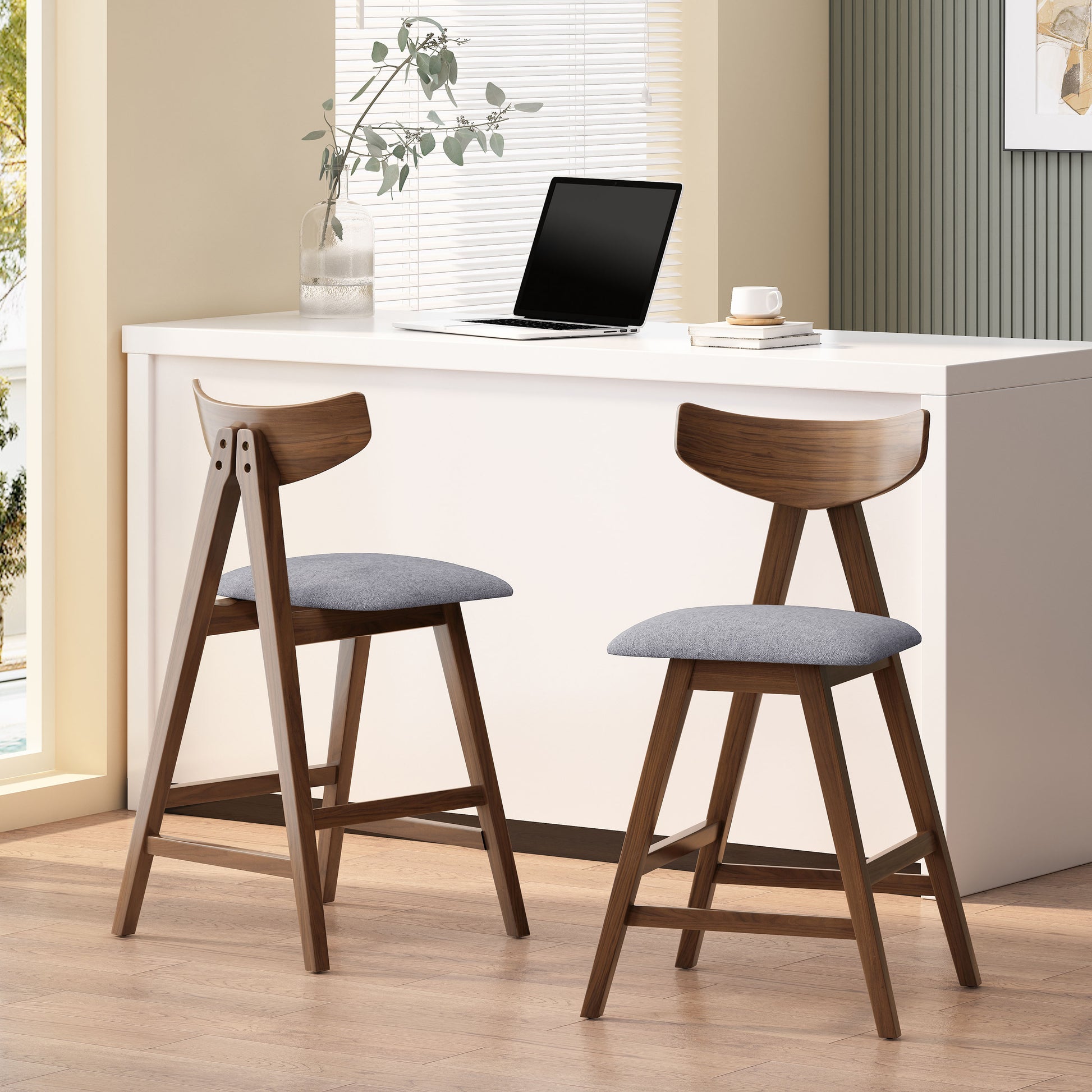 Two midcentury modern walnut bar stools with grey upholstered seats
