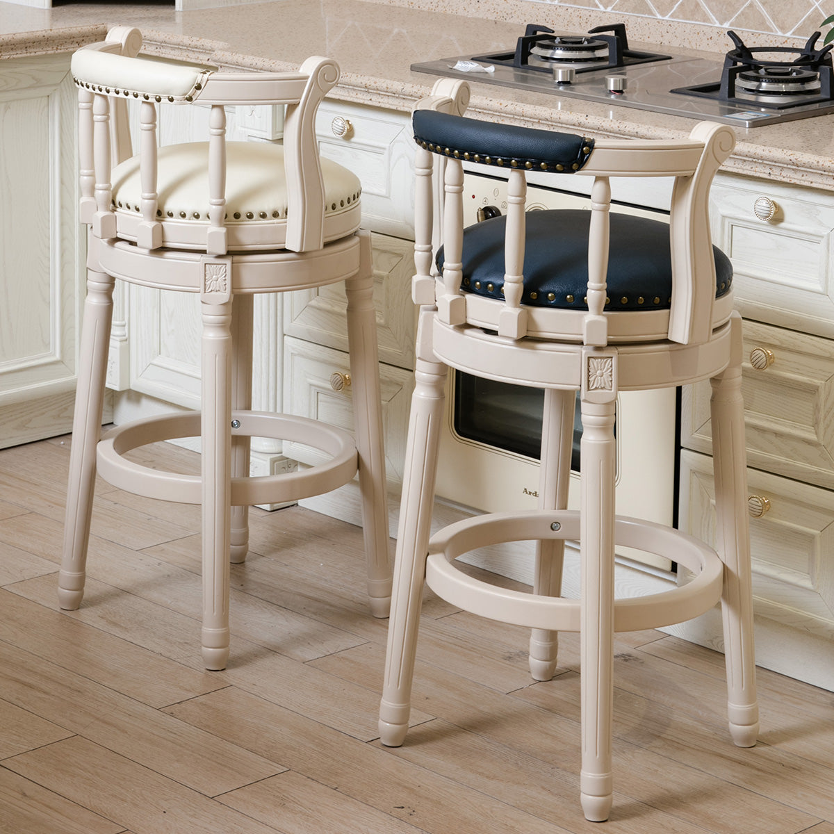 Cream upholstered bar stool with dark blue studded backrest