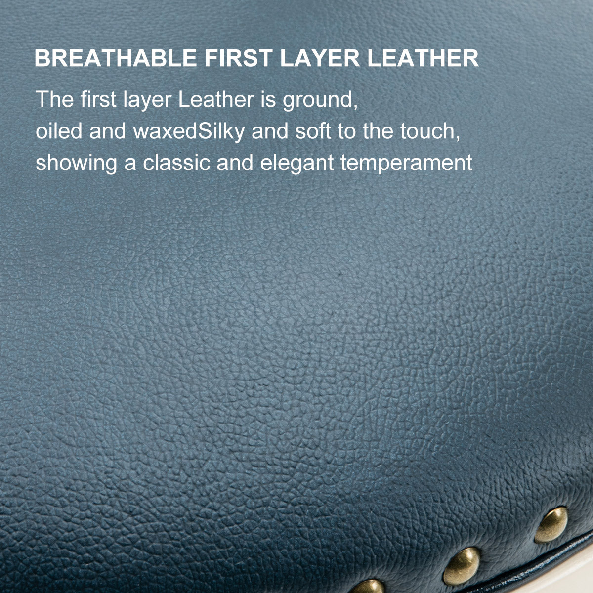 Closeup of textured blue first layer leather upholstery with brass stud details