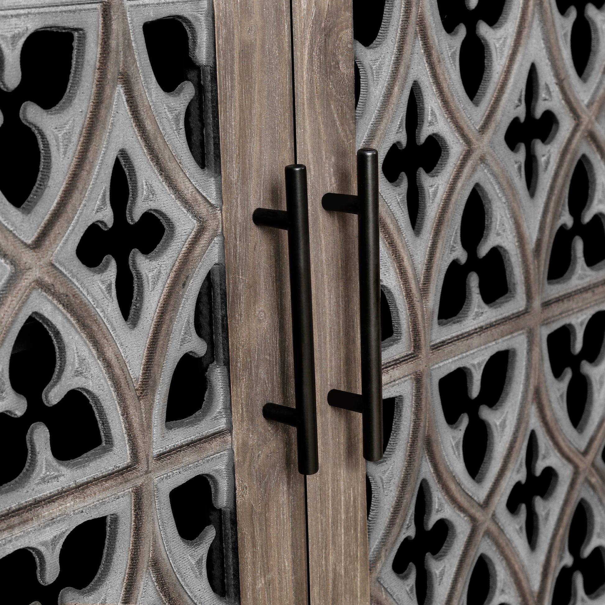 Antique grey carved cabinet door detail with black handles
