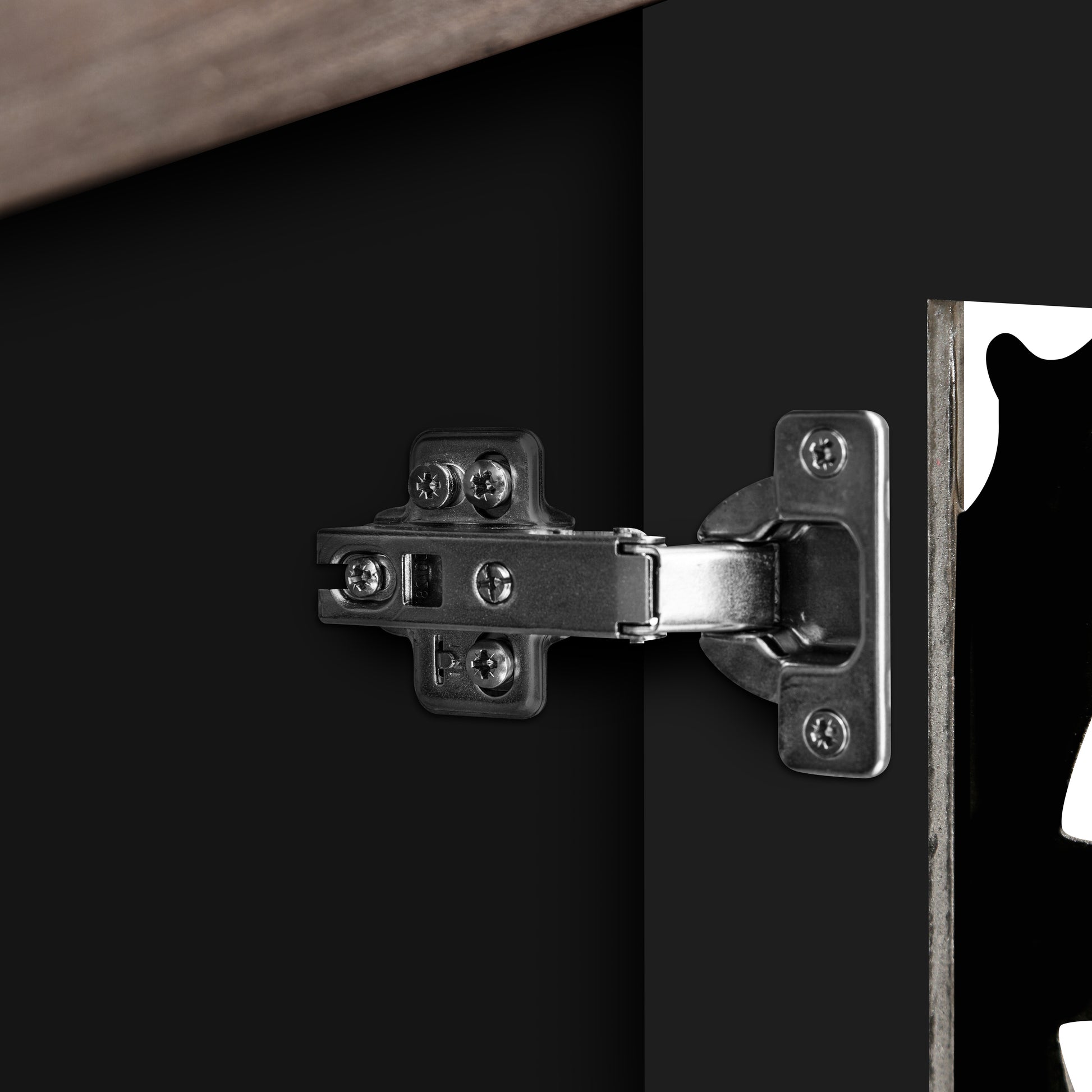 Closeup of a metal cabinet hinge with visible screws