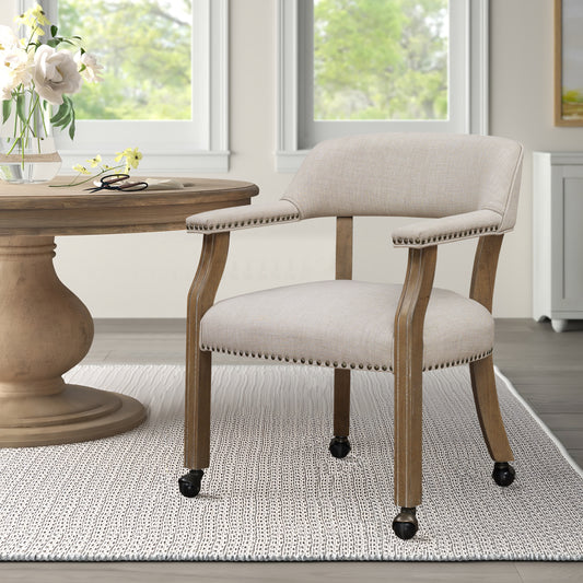 Beige upholstered accent chair with nailhead trim and casters