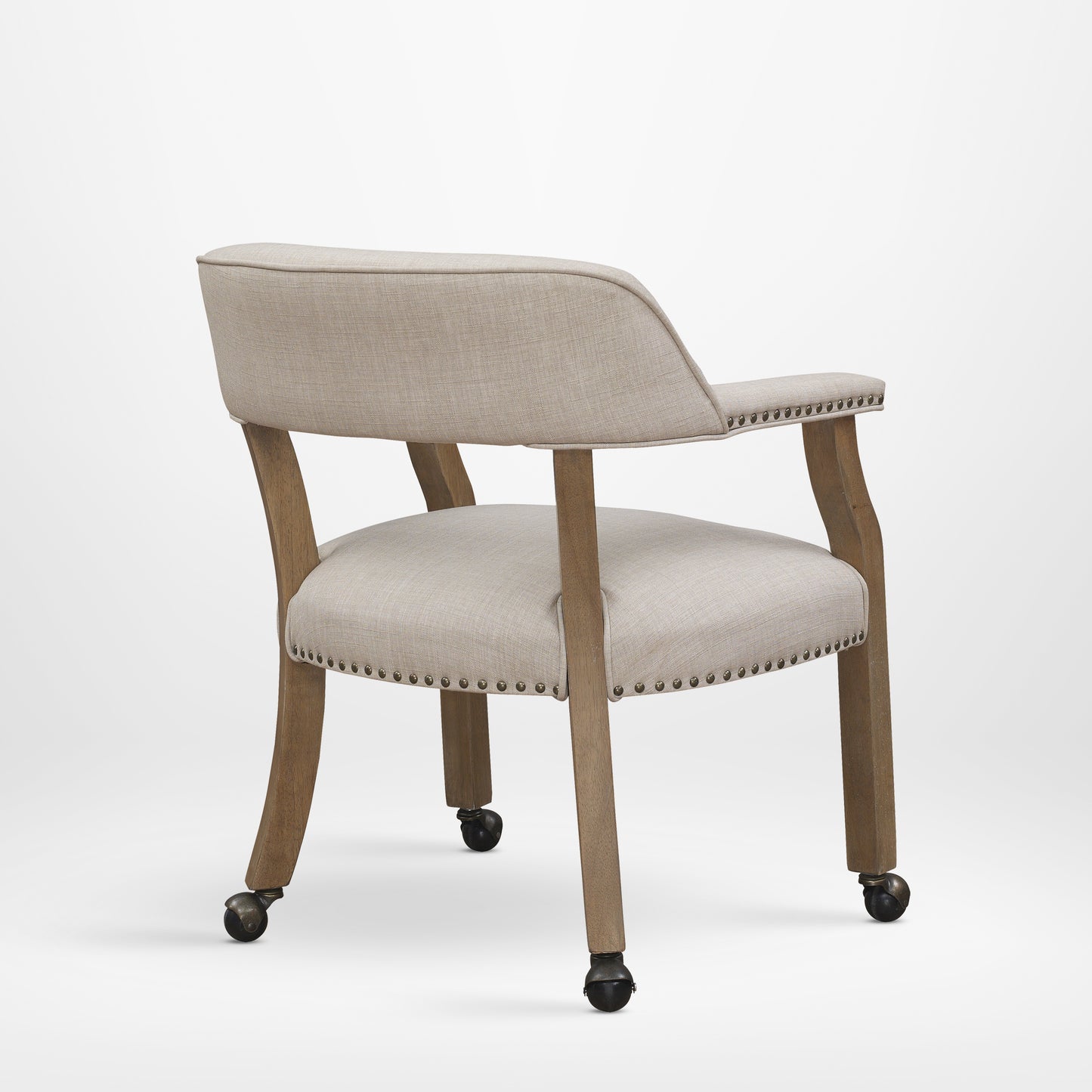 Beige linen upholstered accent chair with nailhead trim and casters