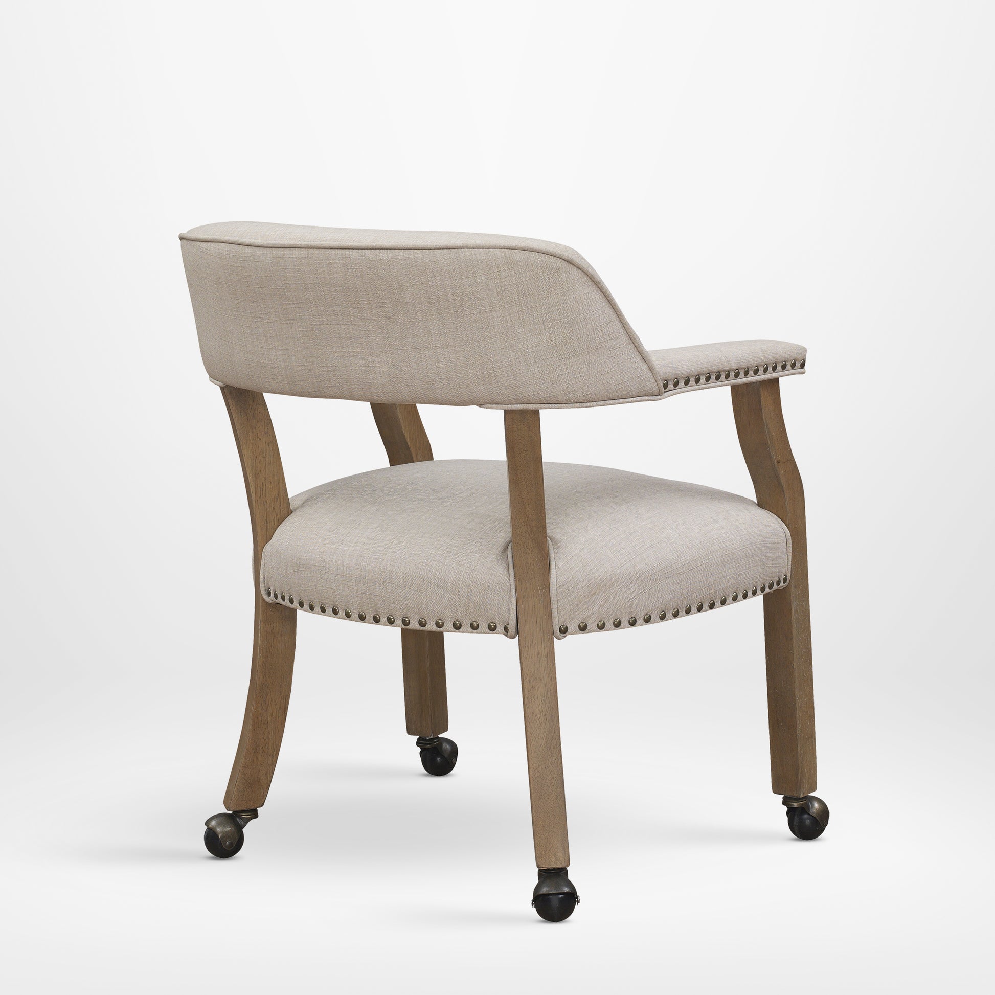 Beige linen upholstered accent chair with nailhead trim and casters