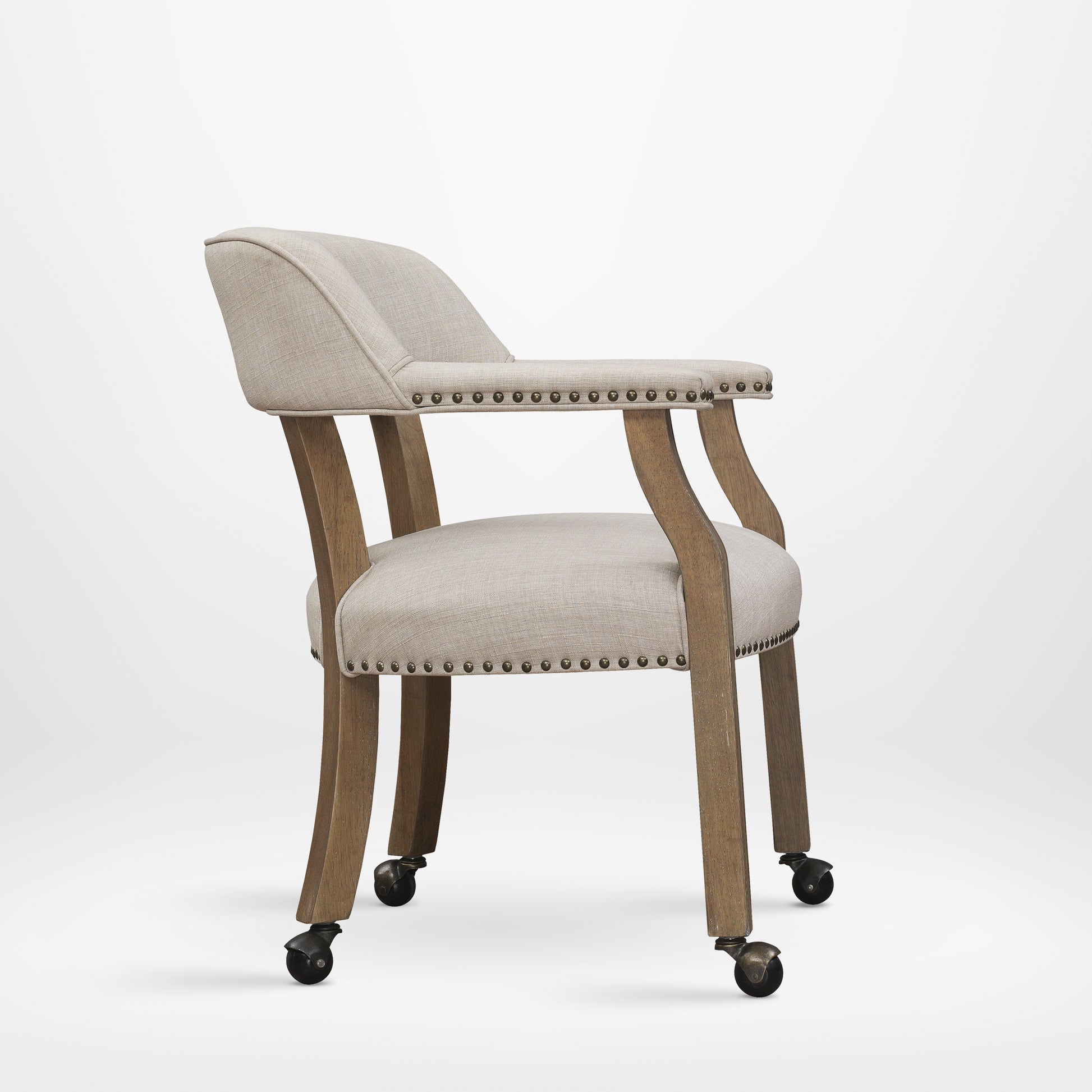 Textured beige upholstered accent chair with wooden legs and brass nailhead trim