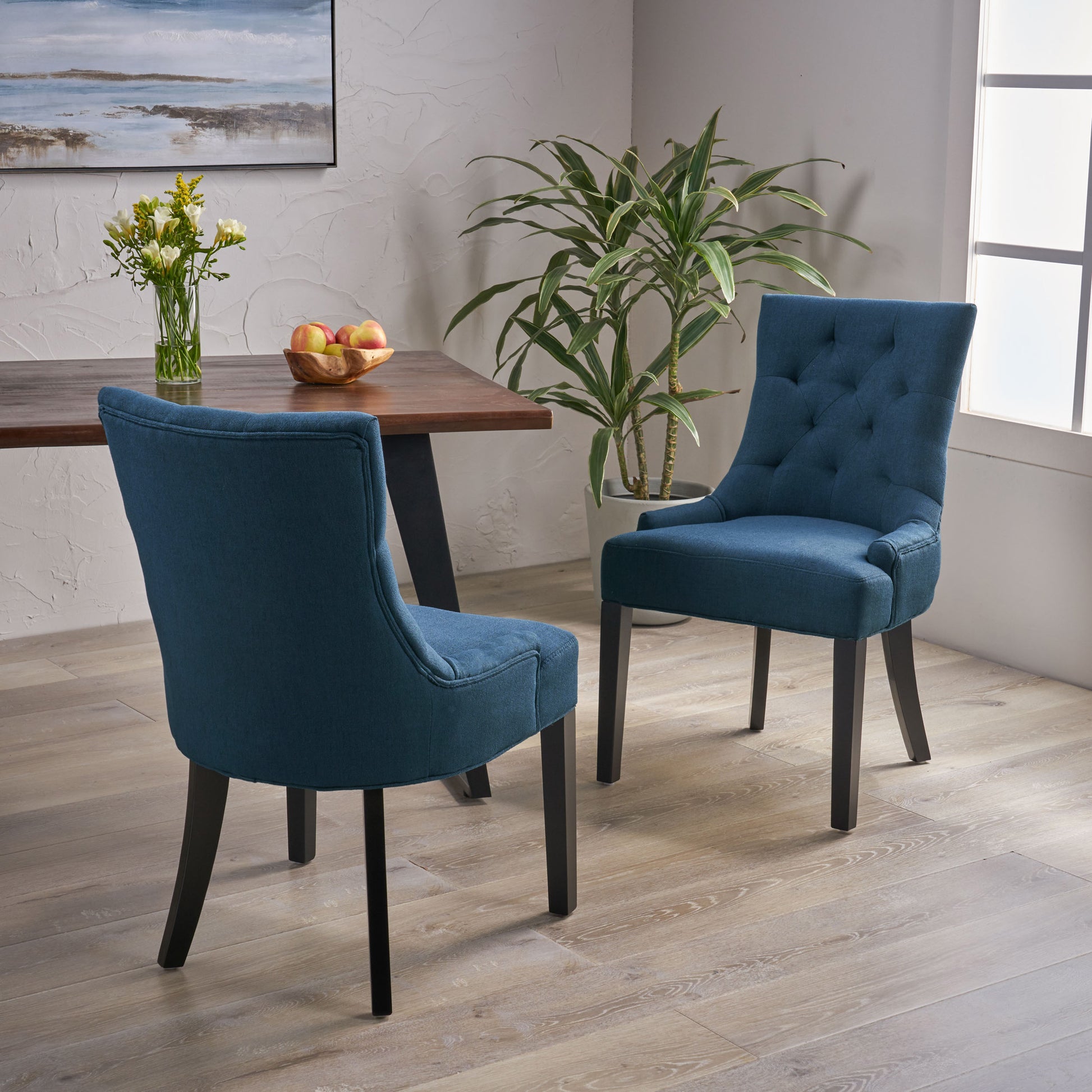 Tufted navy blue upholstered dining chair with dark wood legs