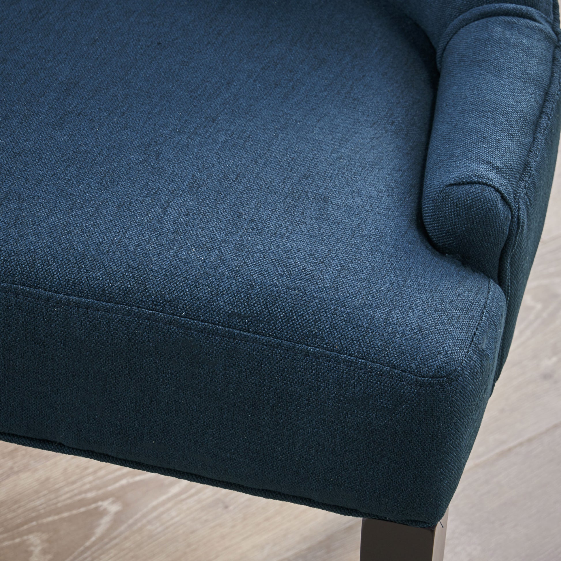 Dark blue textured fabric armchair closeup detail