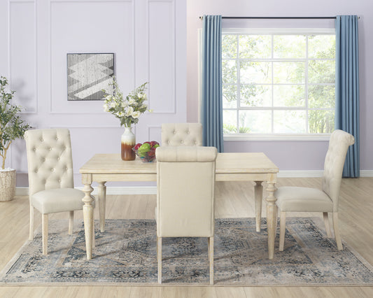 Tufted beige dining chairs around a light wood dining table with a fruit bowl