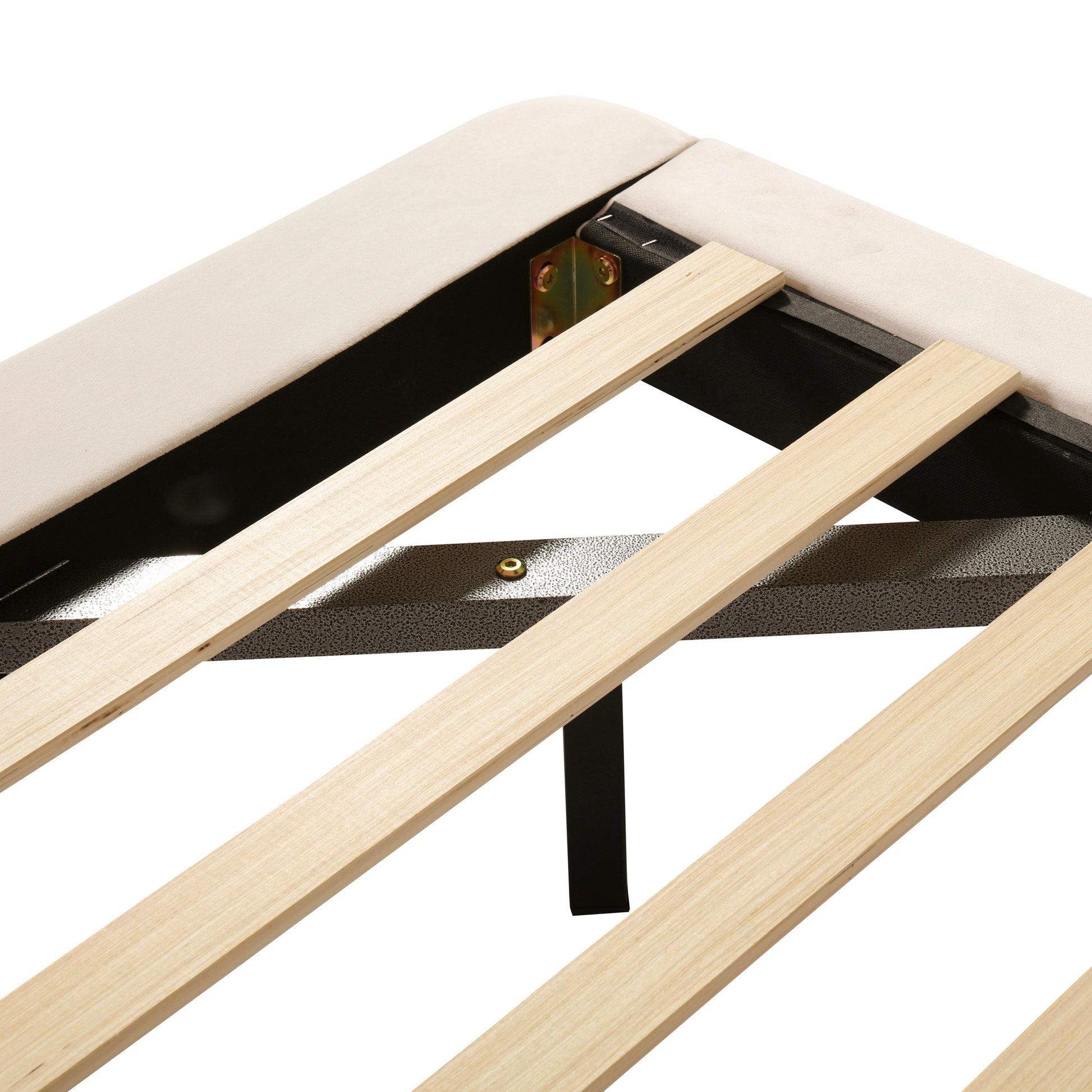 Closeup of beige upholstered bed frame with wooden slats and metal support