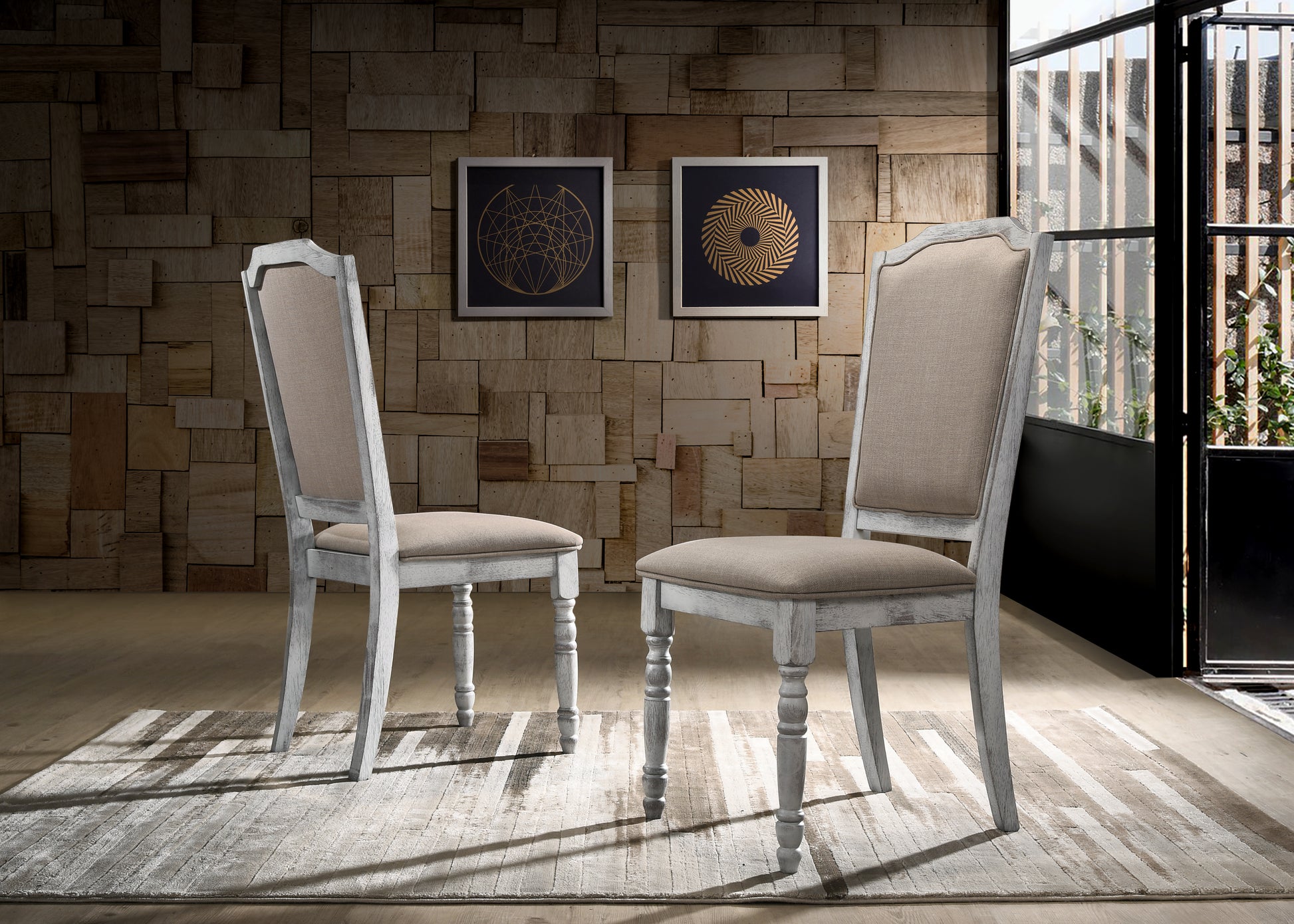 Two whitewashed wooden dining chairs with neutral upholstered seats
