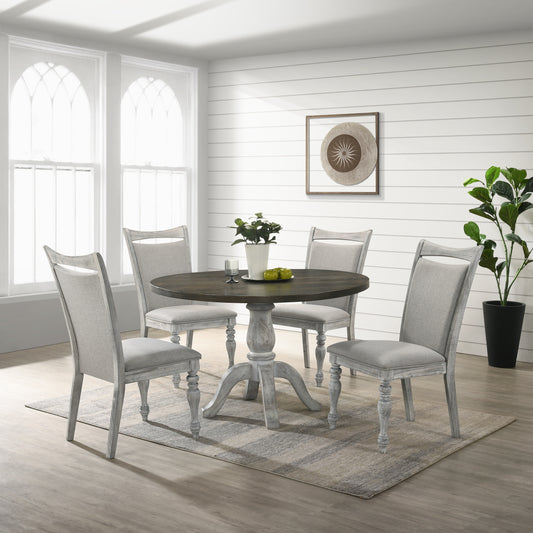 Round wood dining table with pedestal base and four upholstered chairs