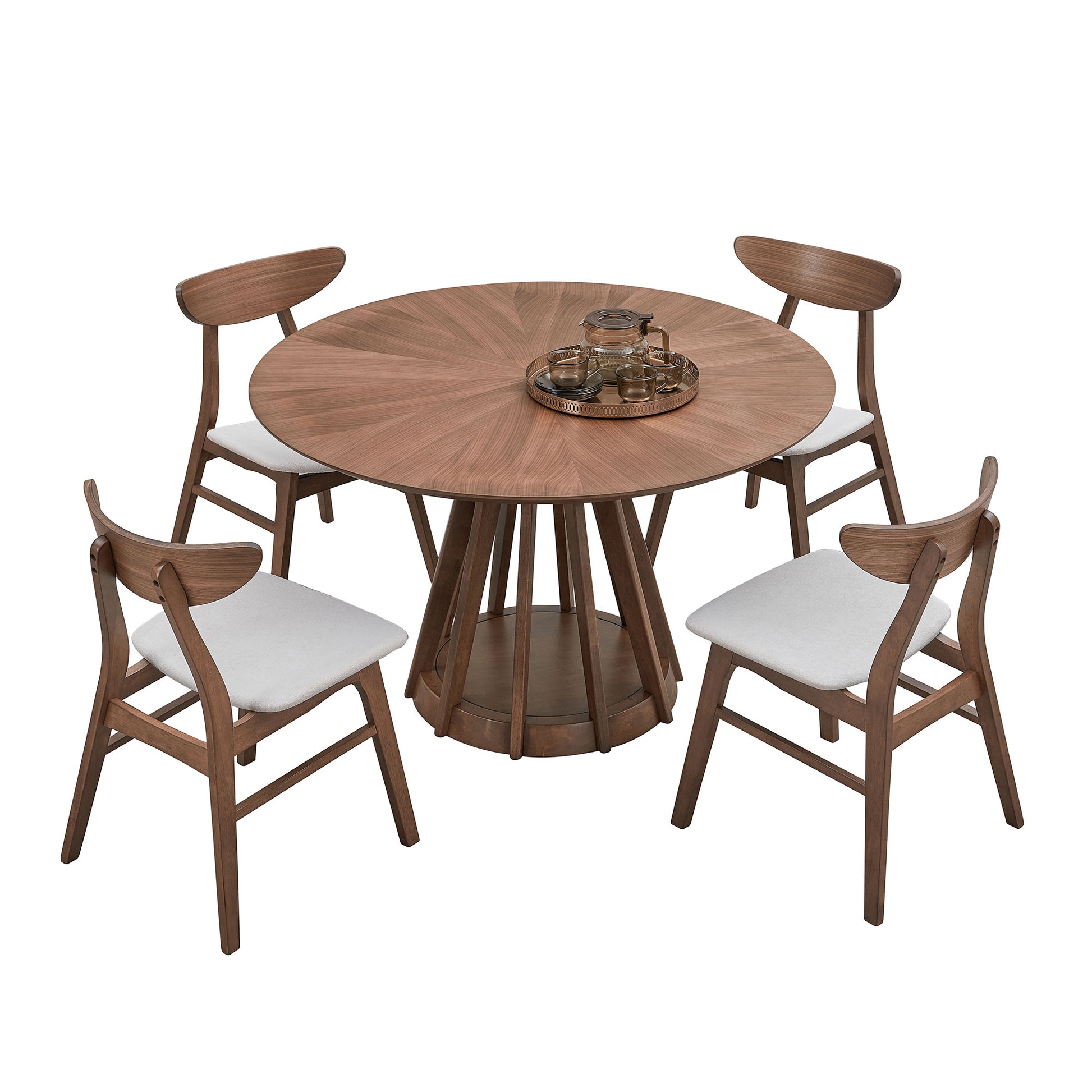 Round wooden dining table with four grey upholstered chairs and a tea set