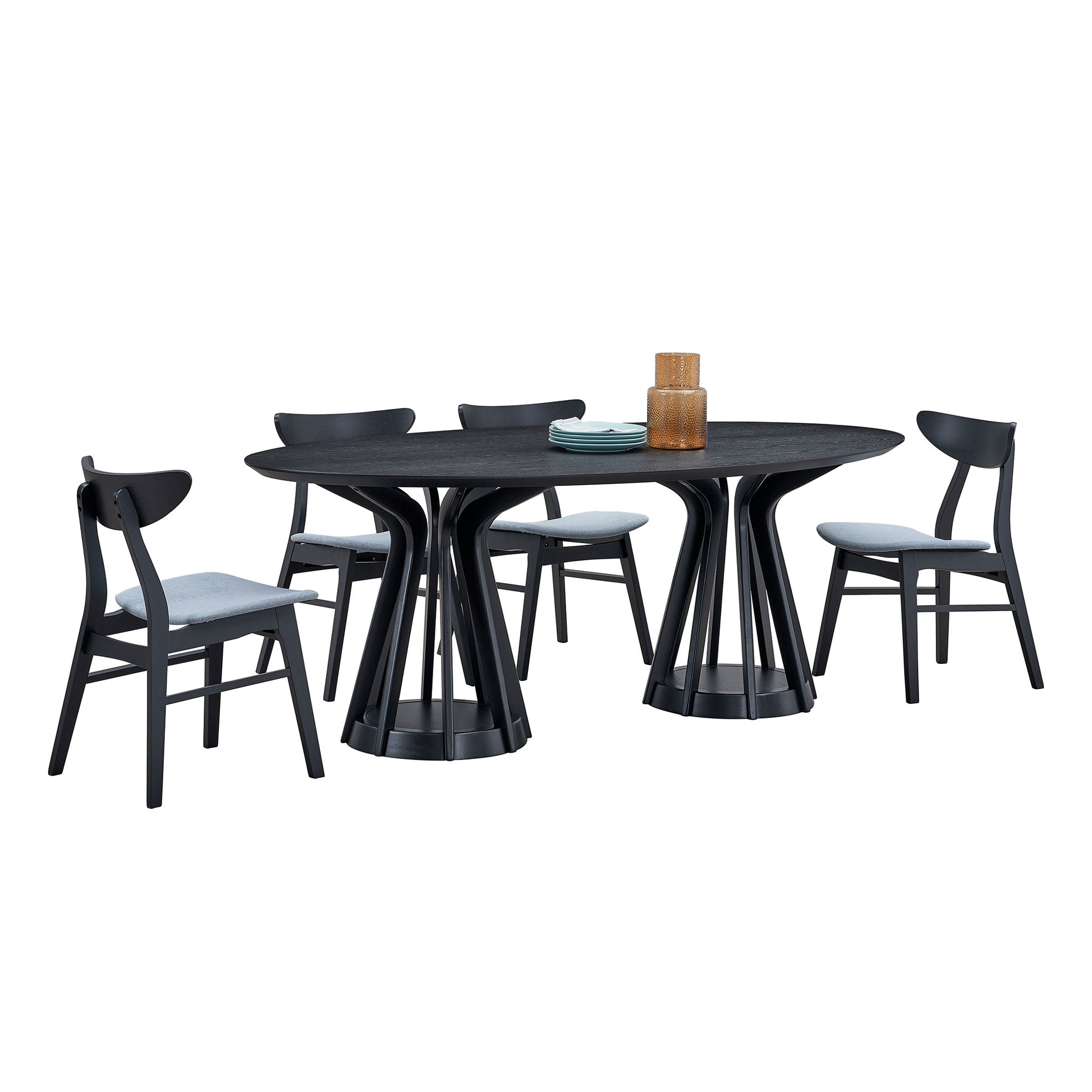 Black oval dining table with four modern upholstered chairs and amber vase
