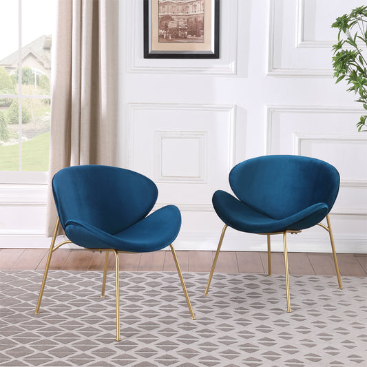 Two elegant teal velvet accent chairs with gold legs on a patterned rug