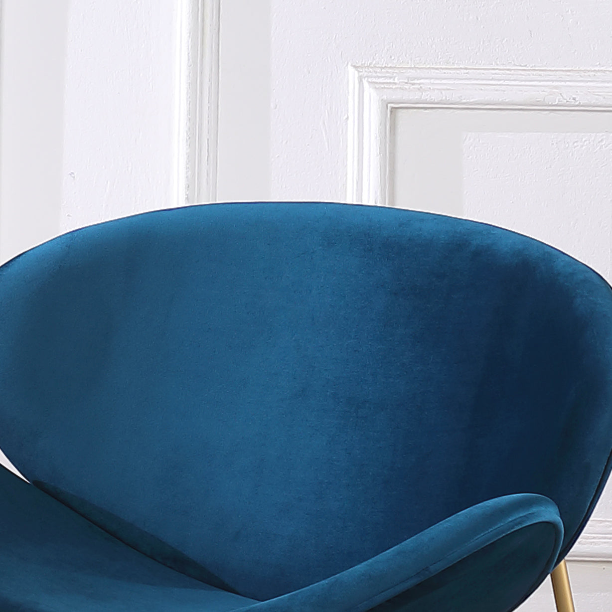 Deep teal velvet accent chair with curved backrest and elegant gold legs