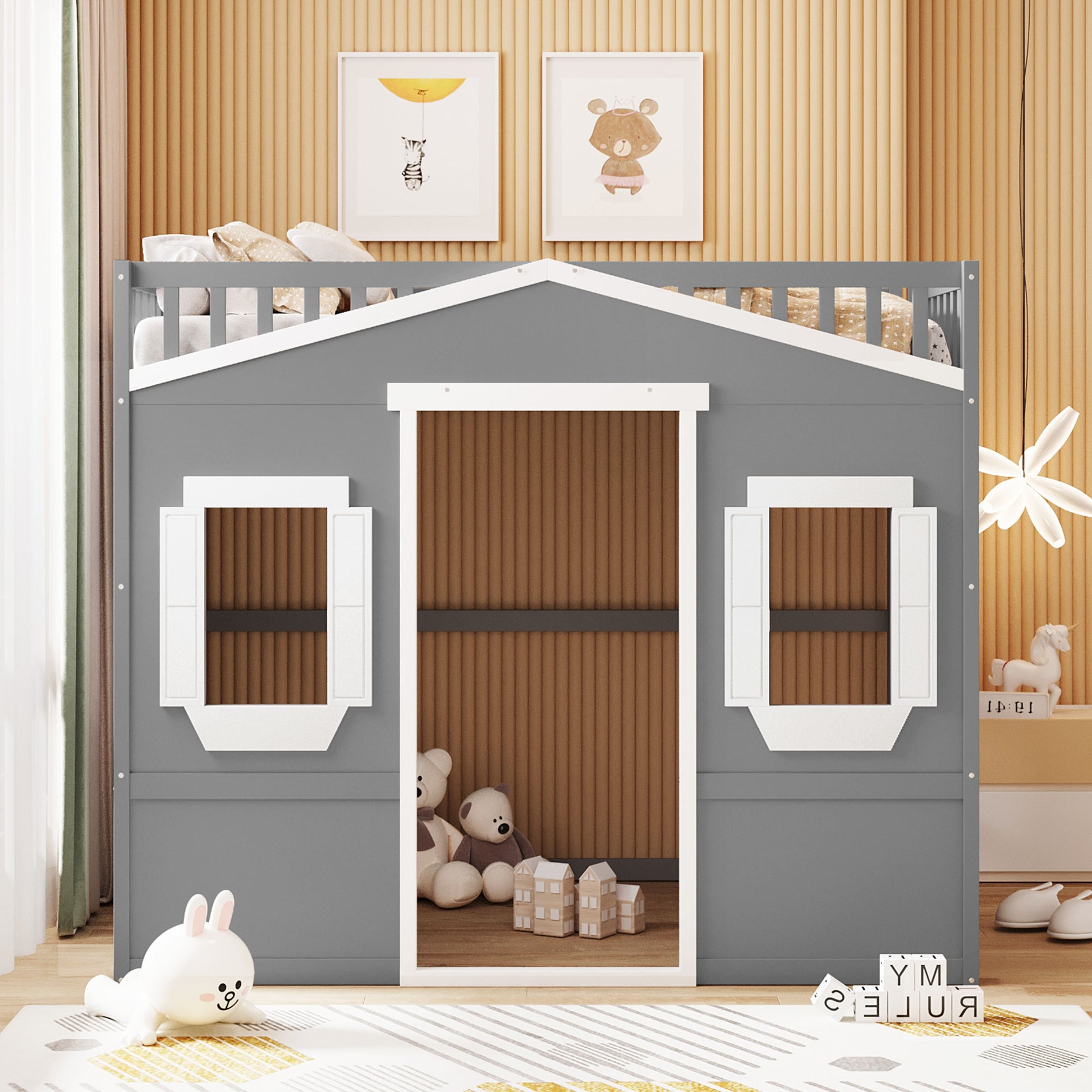 Grey wooden childrens playhouse bed with white trim two windows and a slatted door