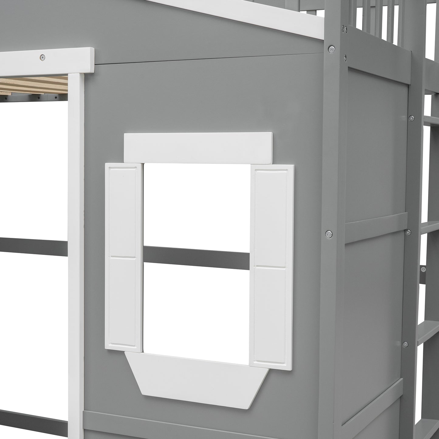 Closeup of a gray wooden toddler bed with a white window frame and shutter detail