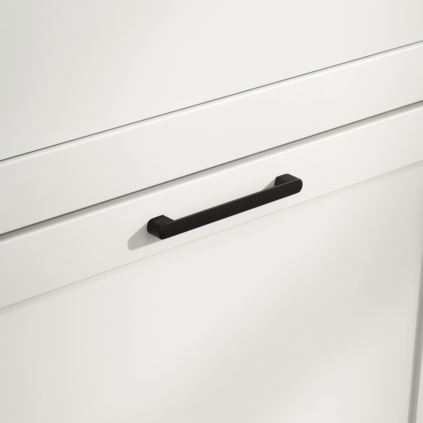 Matte black modern cabinet pull with clean lines on white drawer