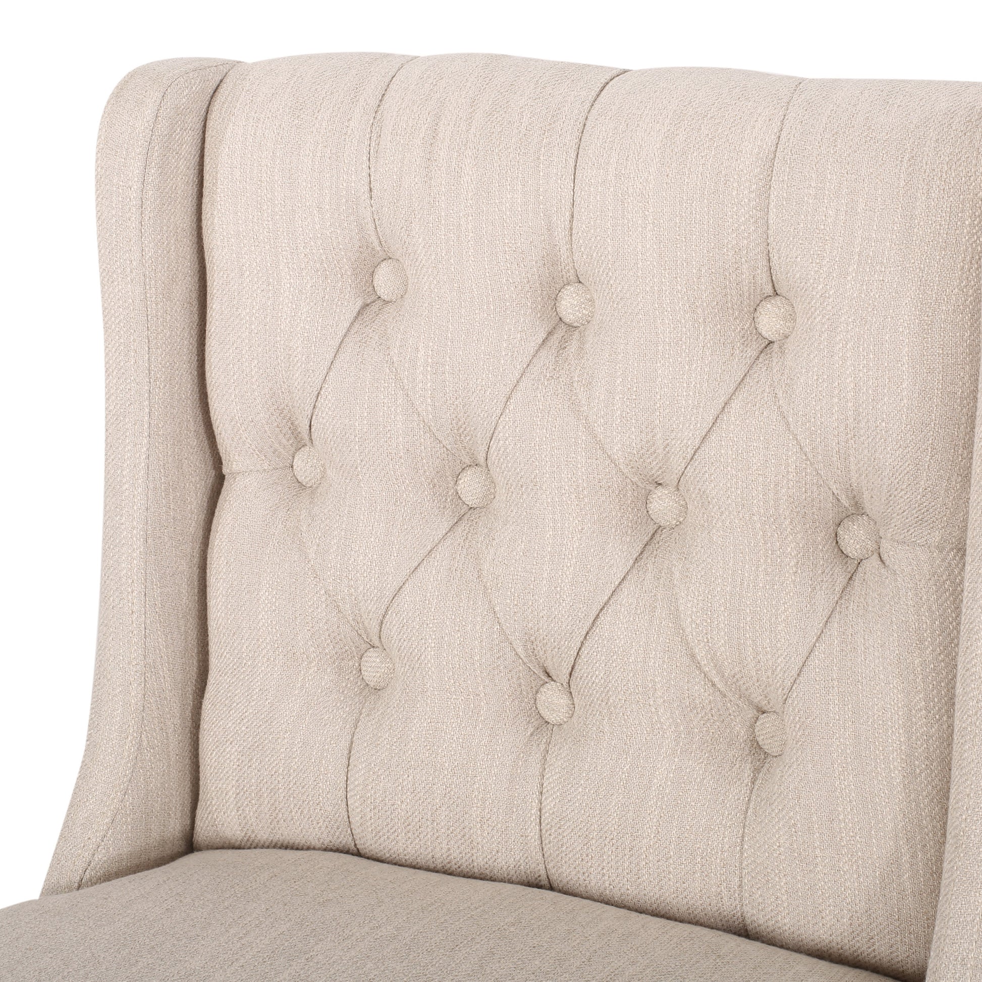 Beige linen wingback armchair closeup showing tufted back detail